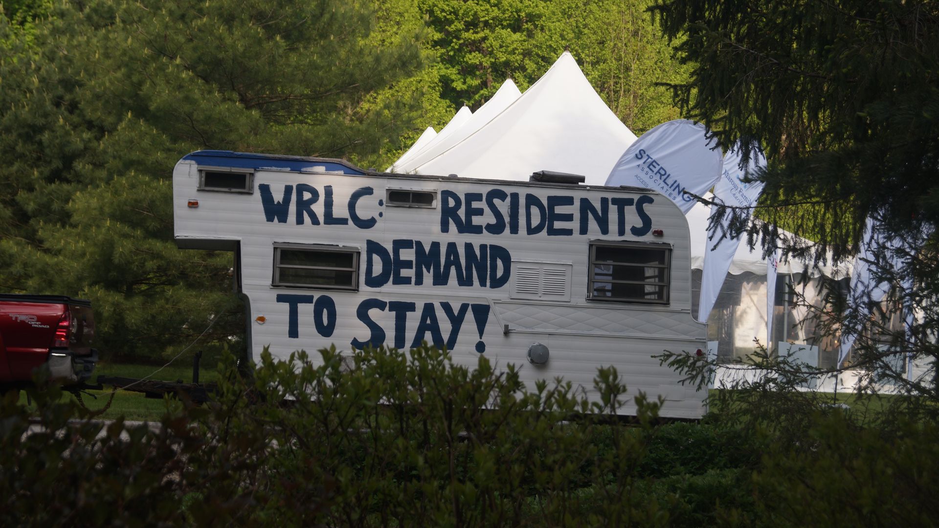 A trailer with a painted message: "WRLC: Residents demand to stay!" 