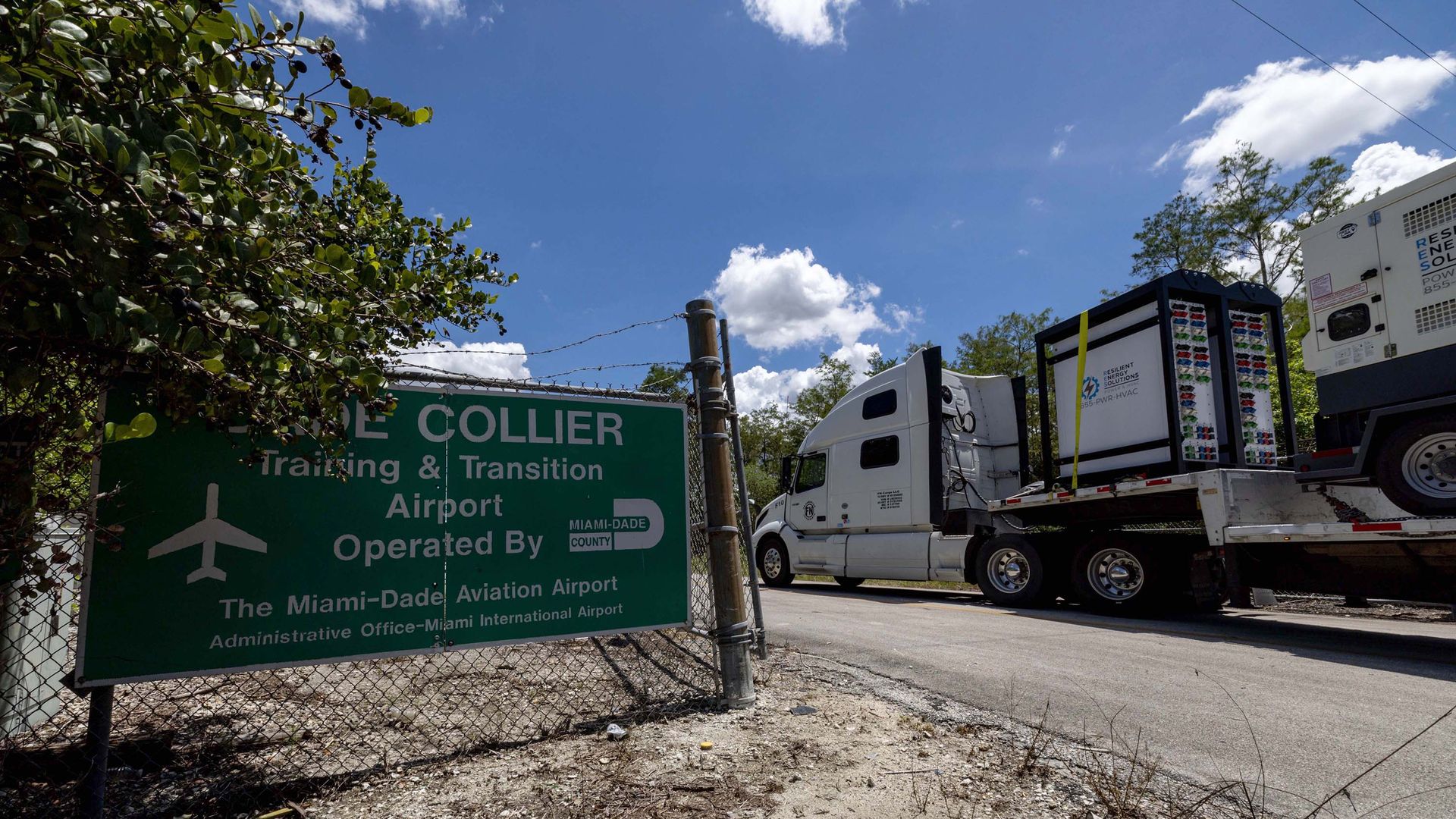A truck driving through a gated entrance.
