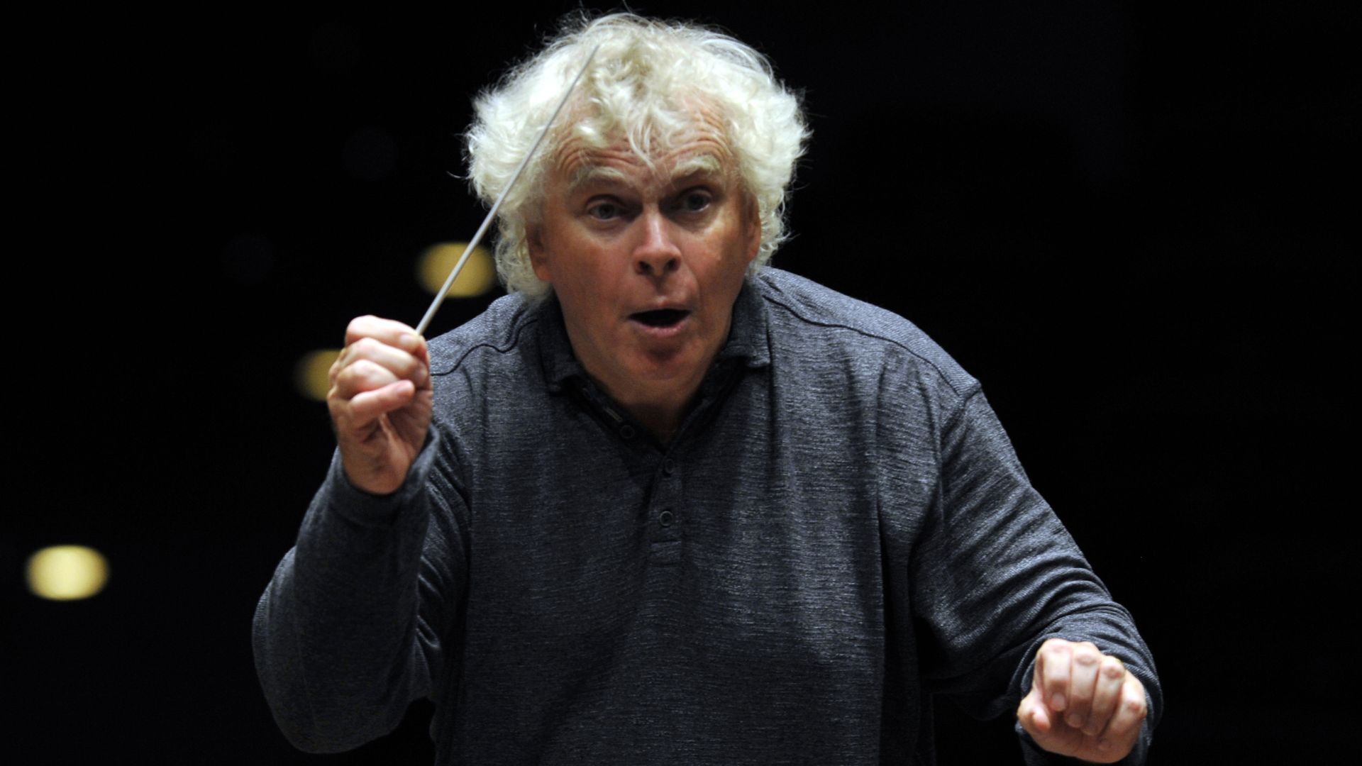 Photo of a man conducting with a baton