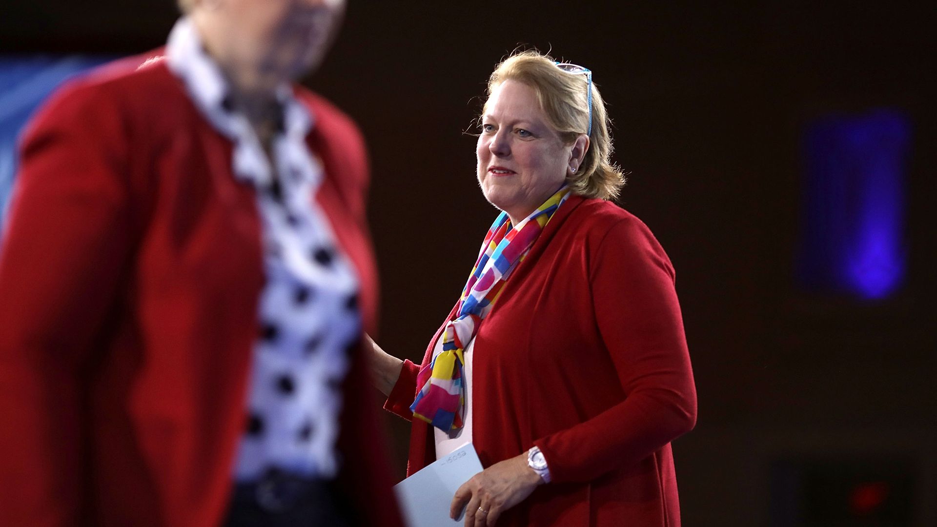 Photo of Ginni Thomas on a stage wearing a red sweater
