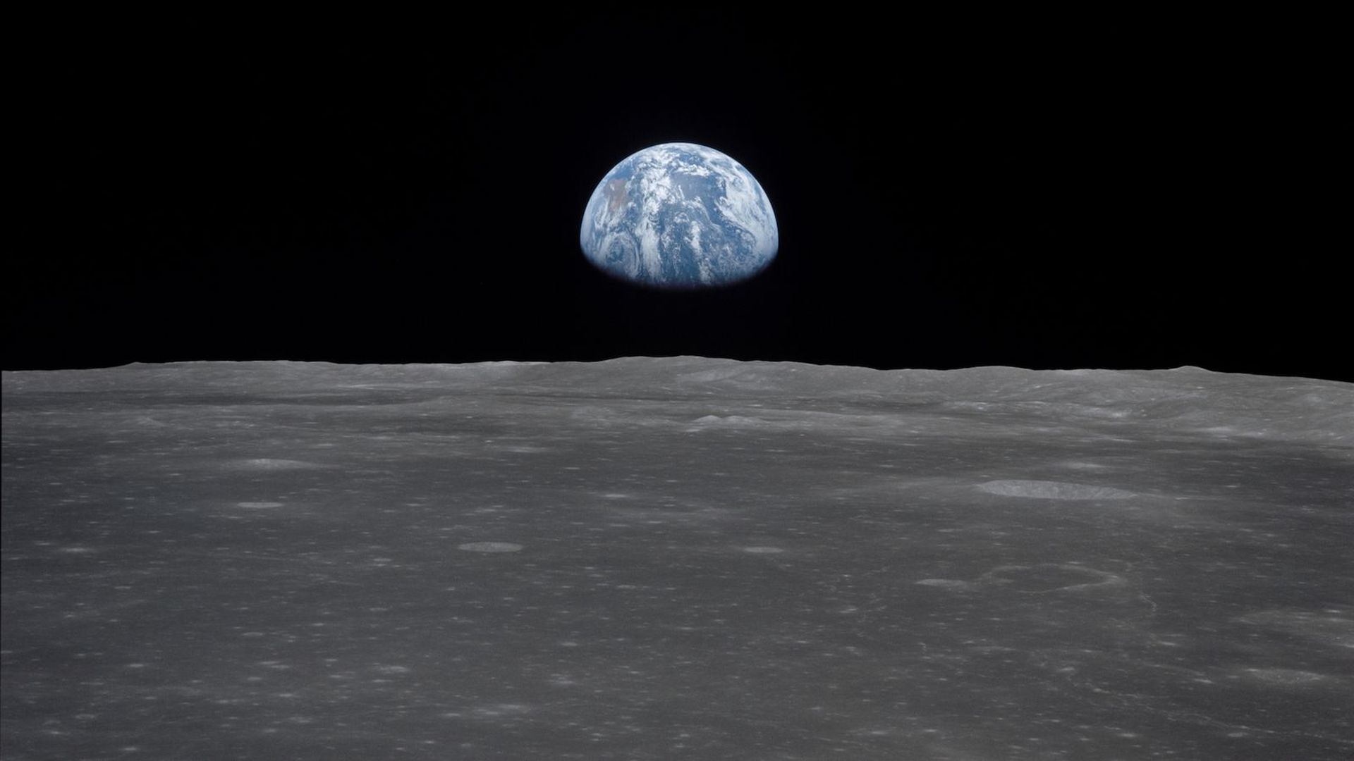 Earth rising above the moon. 