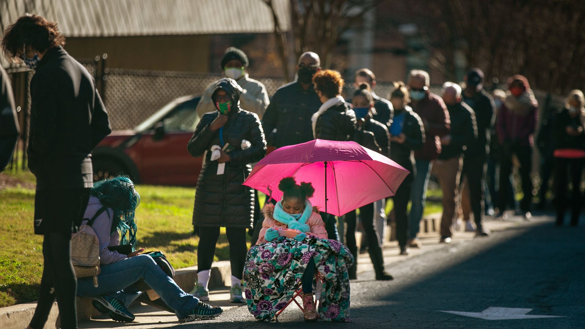 Voters wait in a long line to vote at the Buckhead library in Atlanta on the first day of In-person early voting for the Georgia Senate runoff election on Monday, Dec. 14.