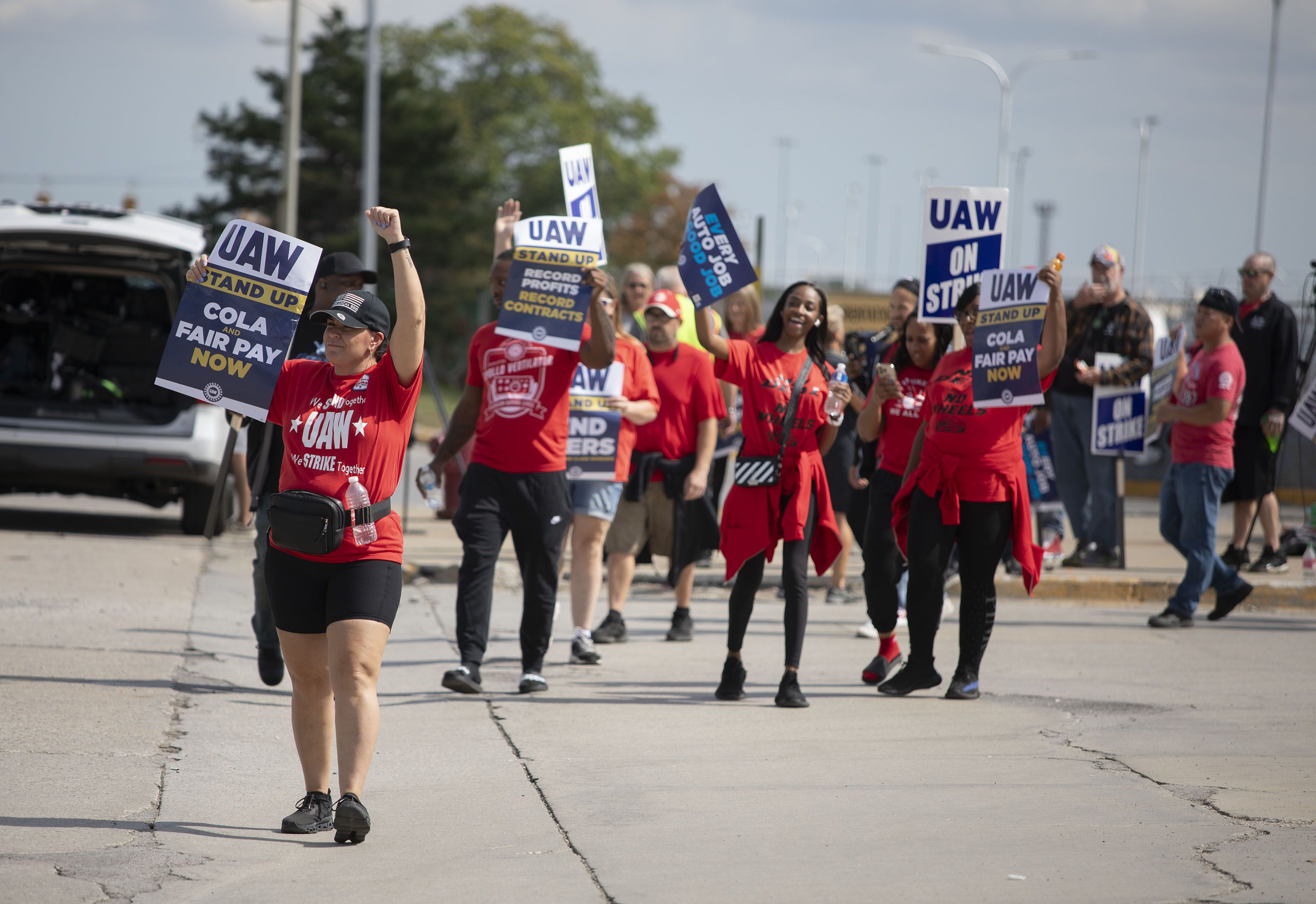 UAW members holding signs outside of a Ford assembly plant in Wayne, Michigan, on Sept. 15.