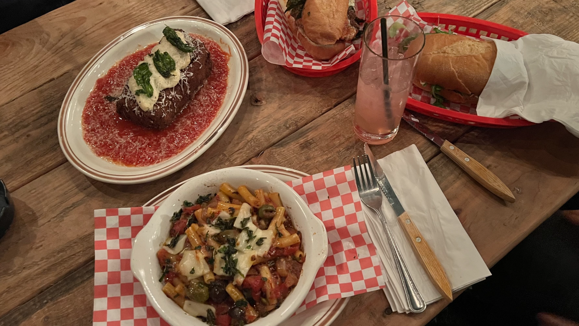 A photo of a table with several dishes of food on it.