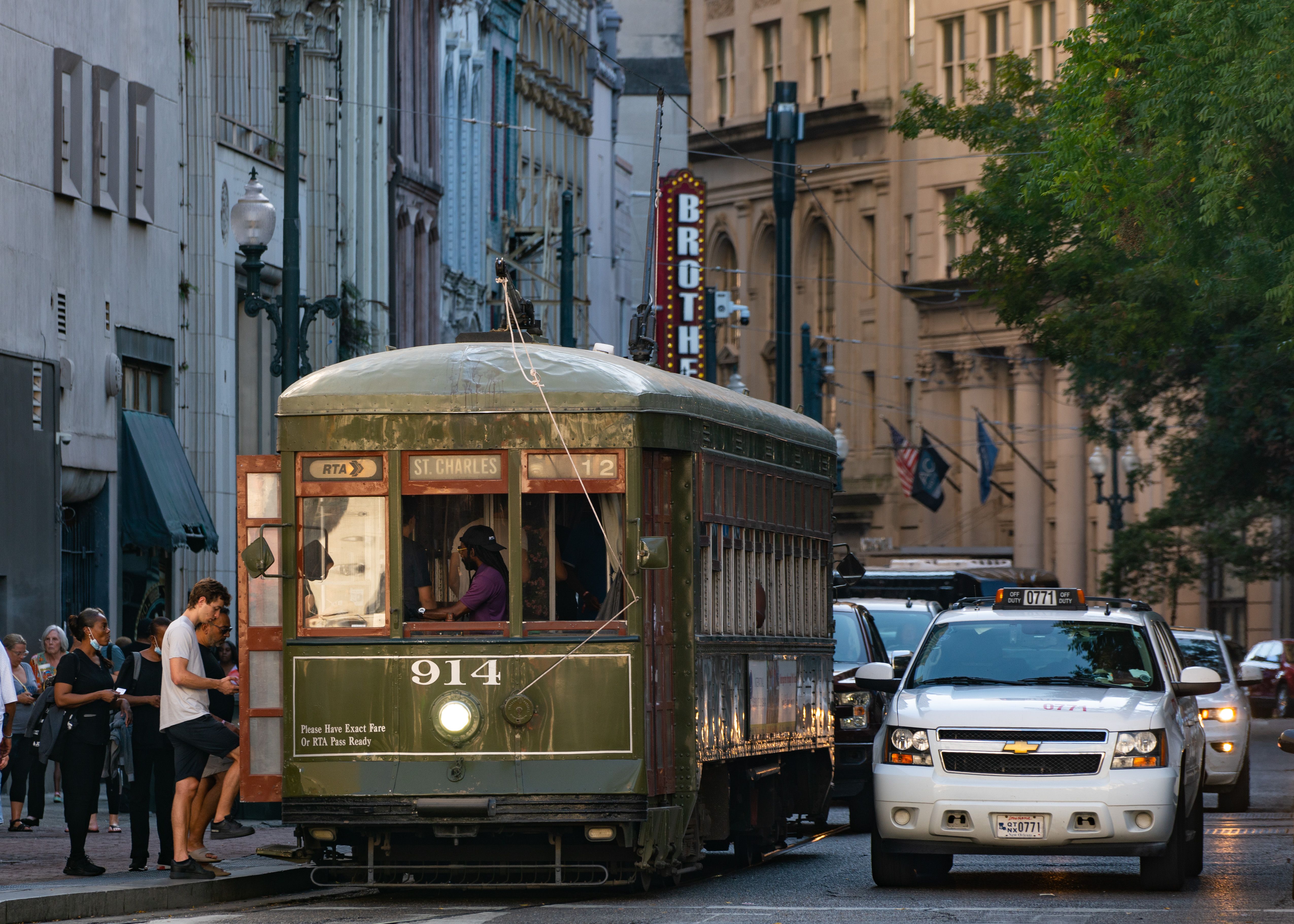 Image shows a green streetcar in New Orleans.