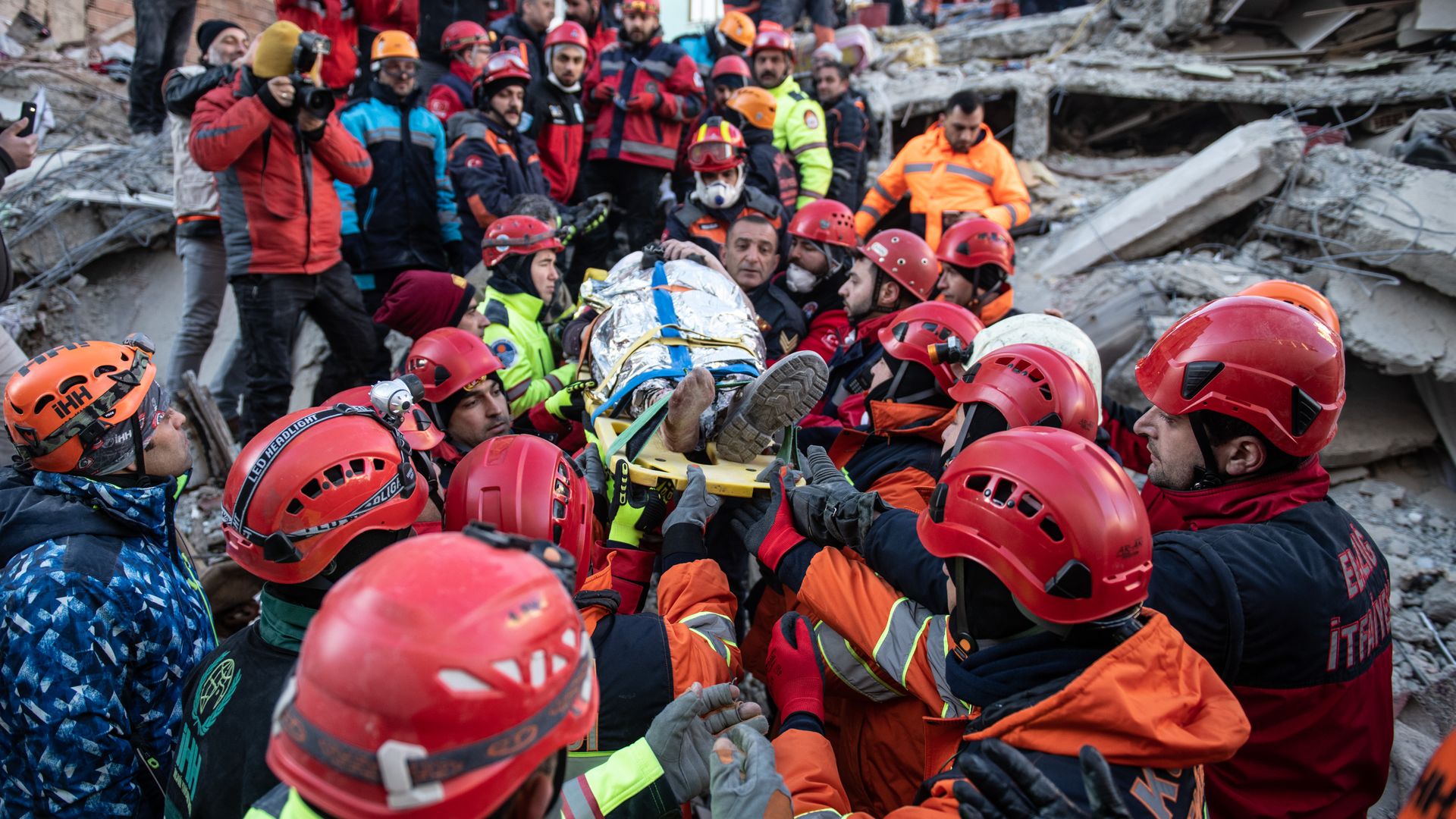 First responders carry a earthquake survivor rescued from the rubble of a collapsed building in Elazig, Turkey.