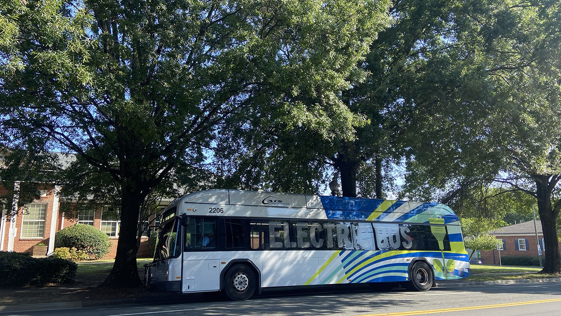 An electric CATS bus is parked at a stop