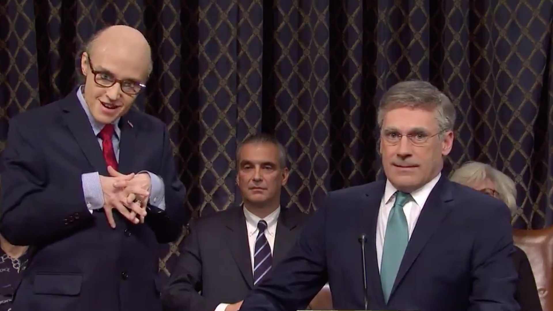A screenshot of Jon Hamm as Bill Taylor, the top U.S. diplomat in Ukraine, and Kate McKinnon as President Trump's personal lawyer Rudy Giuliani.