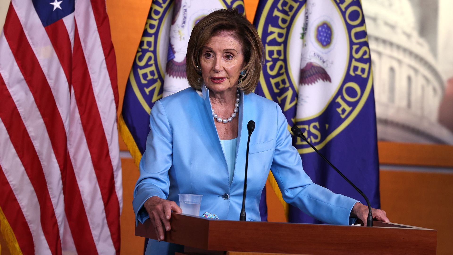 Speaker Nancy Pelosi stands at a podium at the Capitol
