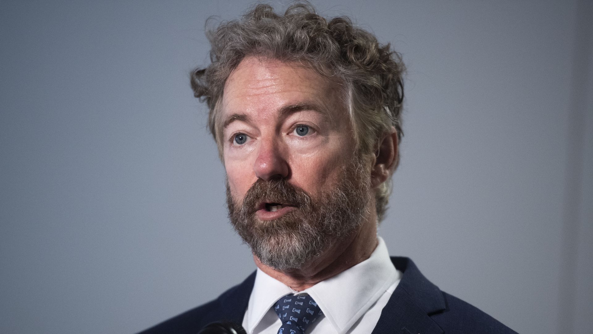 Sen. Rand Paul stands in a suit and tie