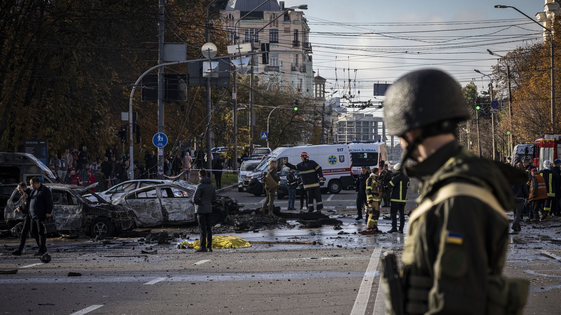 Emergency service personnel attend to the site of a blast on October 10, 2022 in Kyiv, Ukraine.