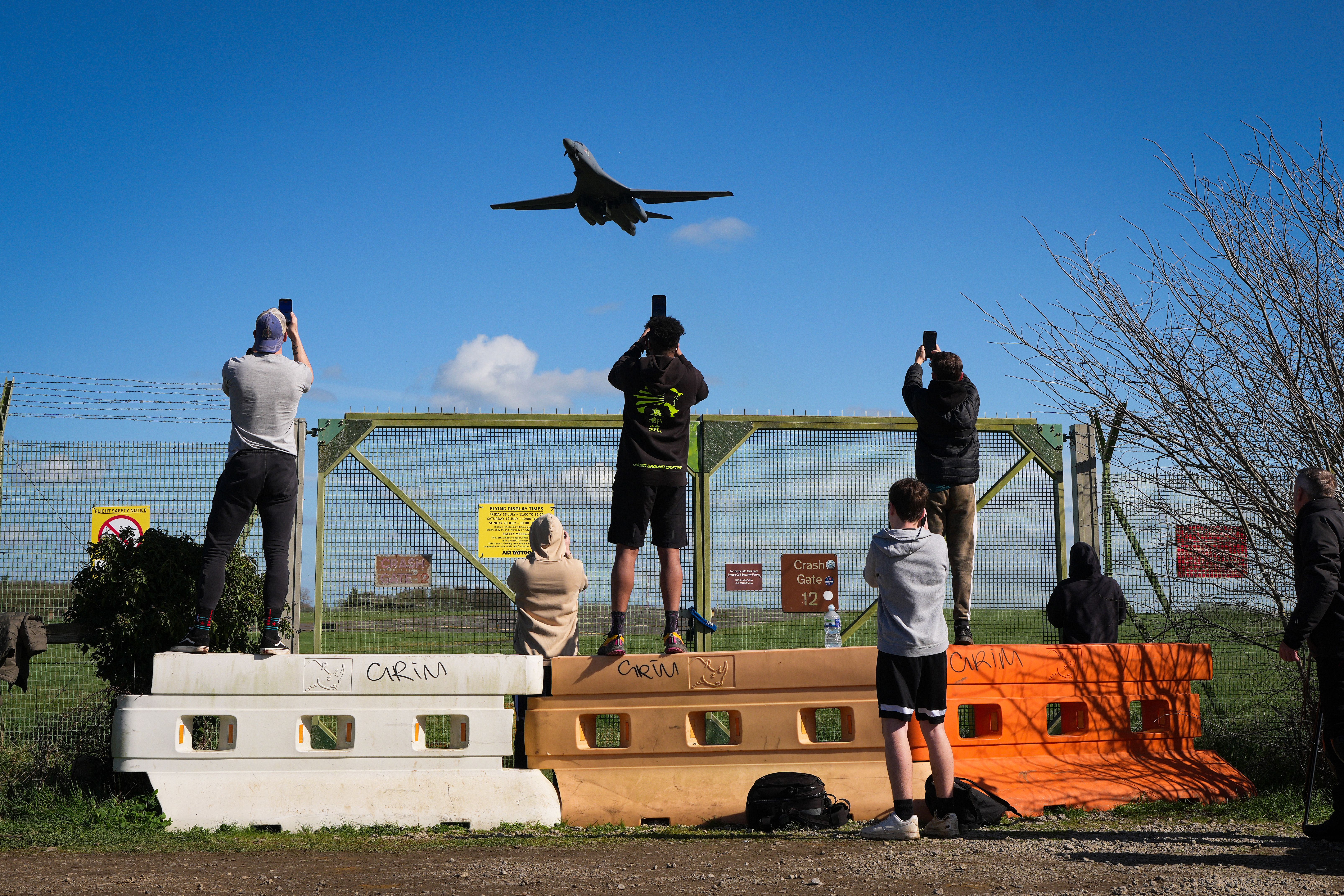Plane spotters and aviation enthusiasts watch a B-1 bomber take off at RAF Fairford in March.