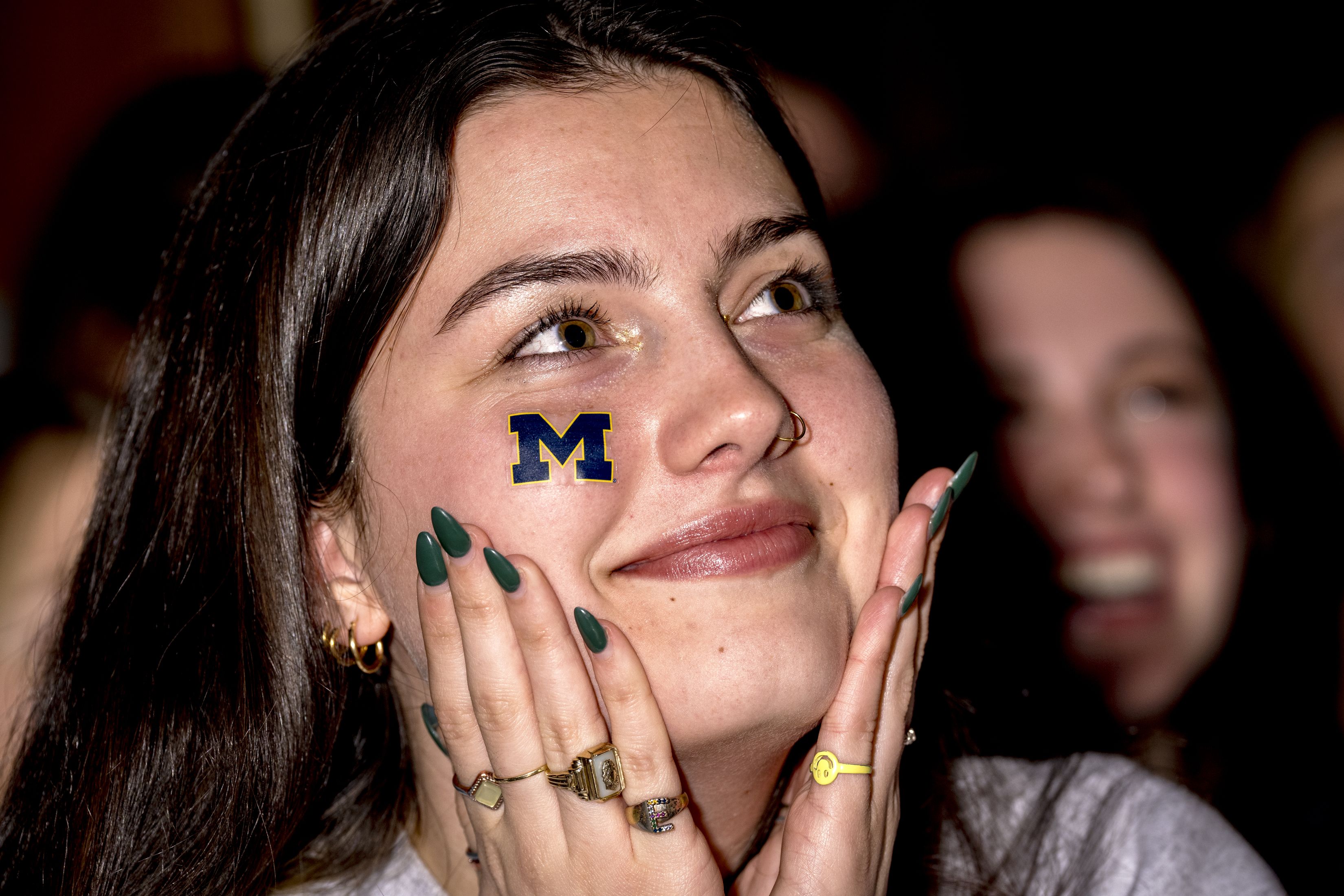 fan watches the 2024 College Football Playoff National Championship Game against the Washington Huskies on January 08, 2024 at the Brown Jug Restaurant in Ann Arbor, Michigan. (Photo by Nic Antaya/Getty