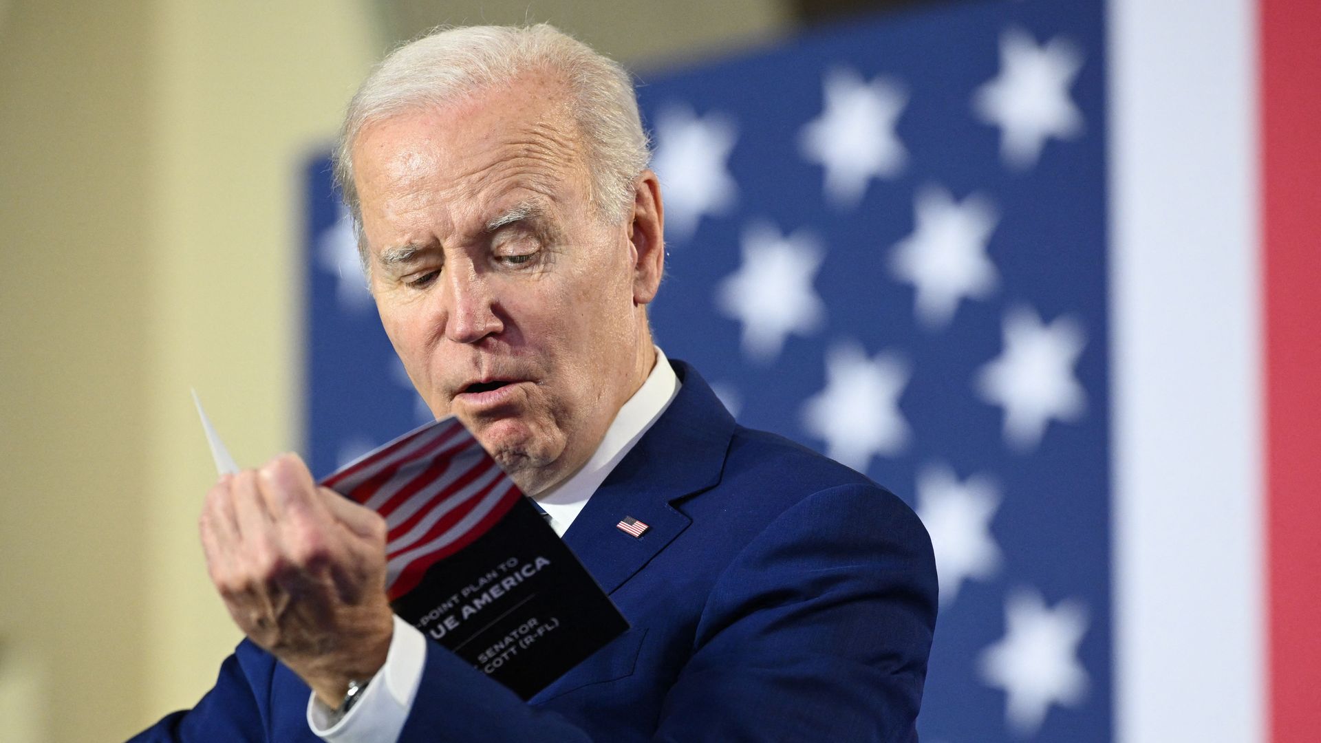 Biden reading from pamphlet