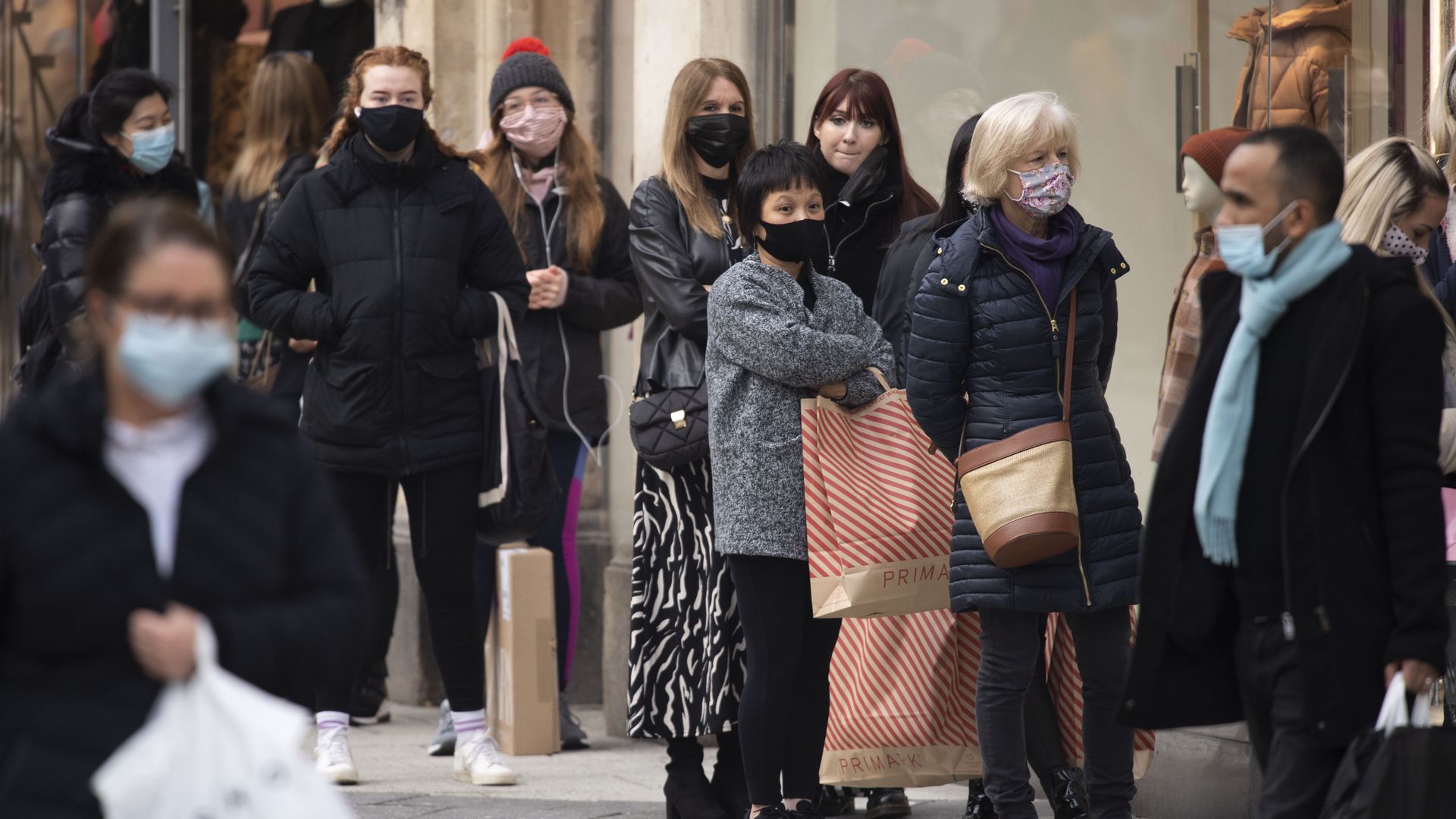 Shoppers lining up in front of a store on Black Friday
