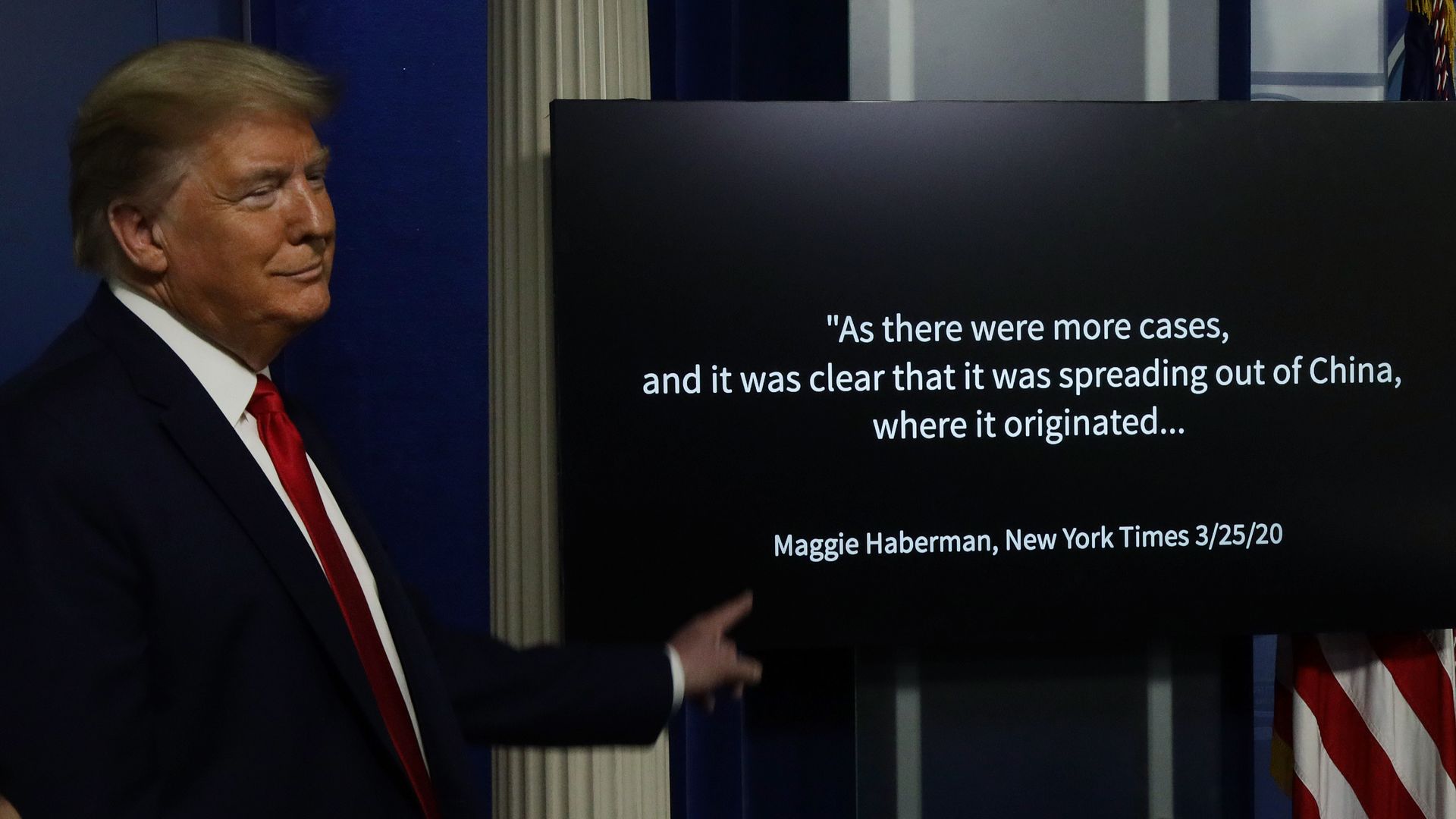 Trump pointing to a TV