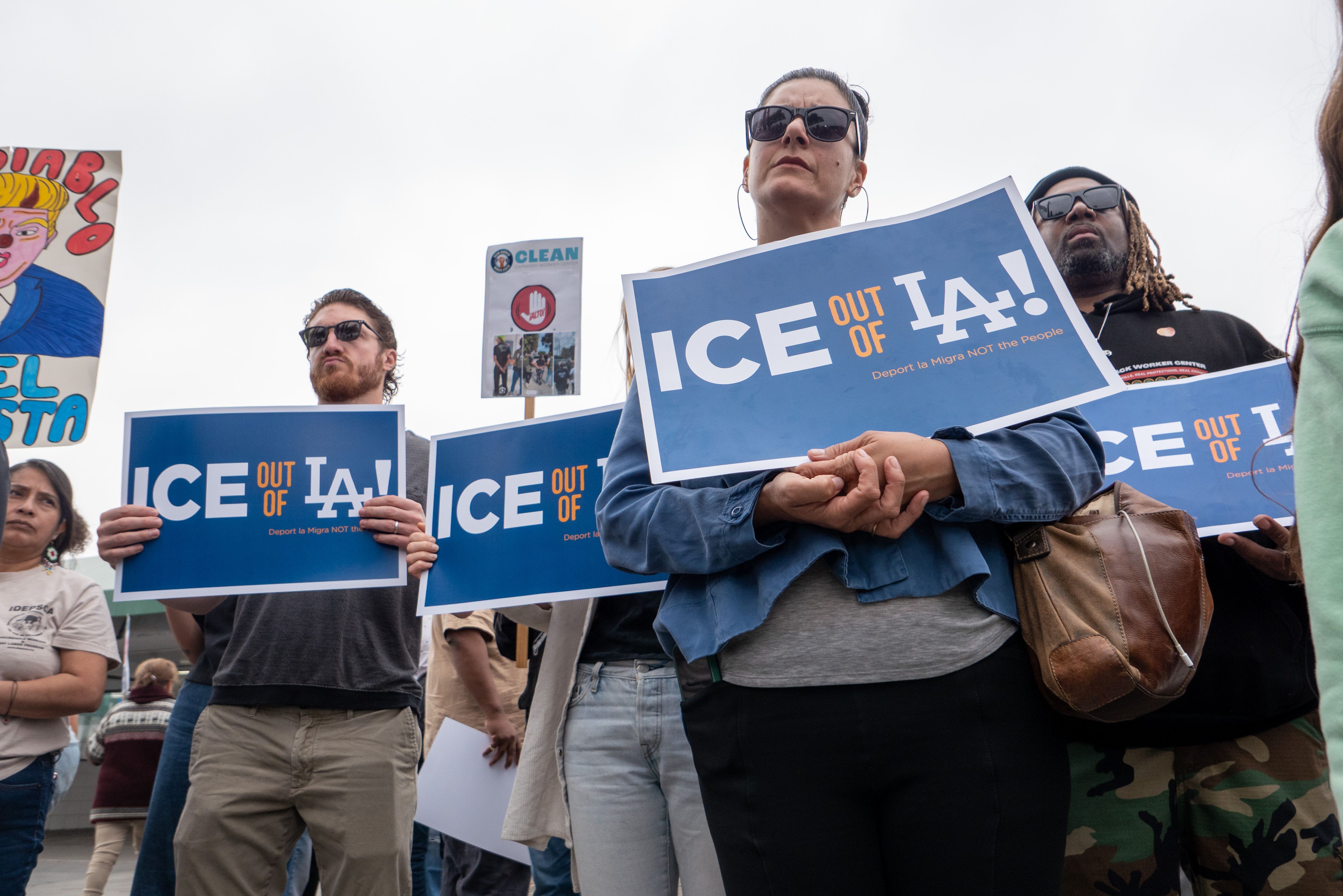 Protesters gather outside a Los Angeles car wash where workers were detained by ICE agents last week.