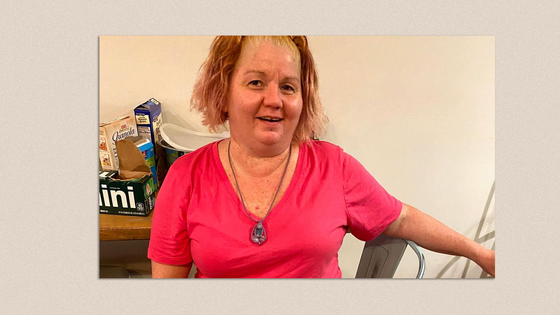 Jessica Witzel wearing a pink shirt and a necklace and smiling at the camera.