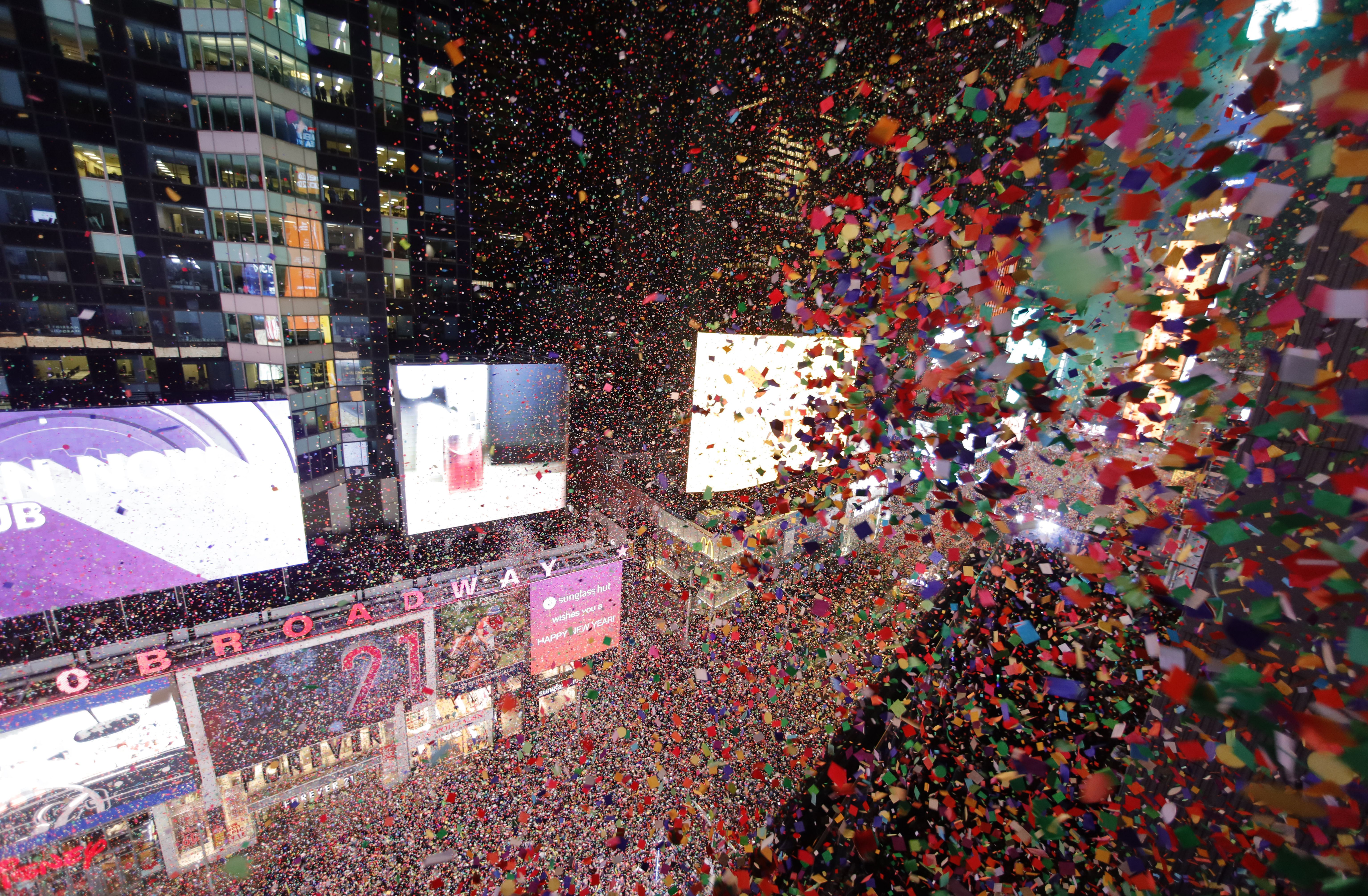 Confetti fills the air over top of revelers in New York City's Times Square.