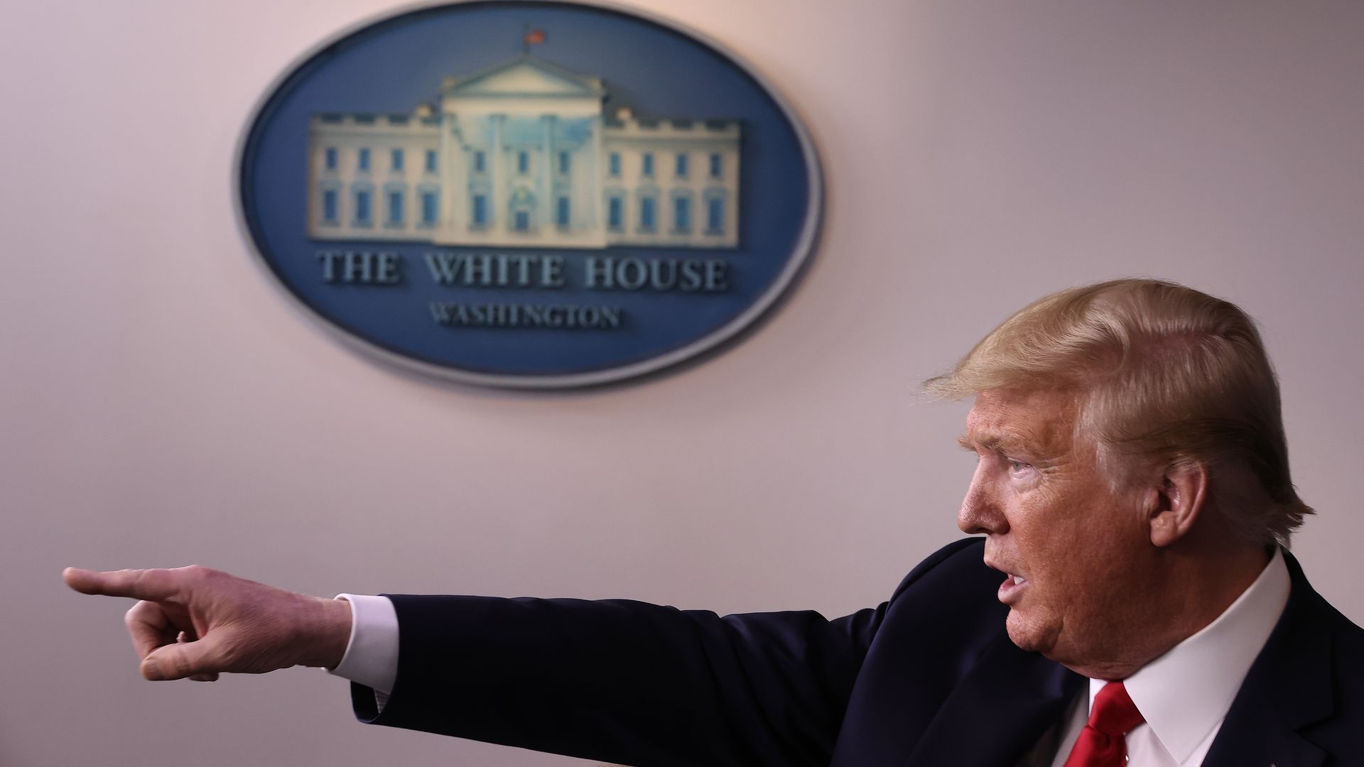 President Trump pointing in the White House briefing room