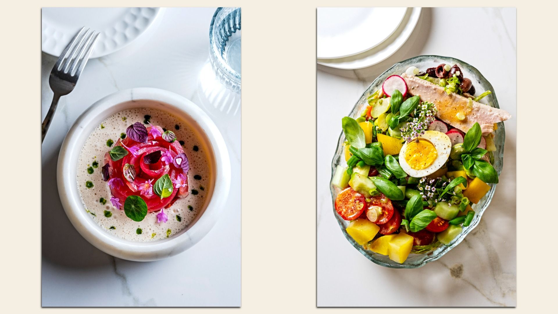 Two plates on a white marble table: left bowl with creamy soup garnished with red petals and green herbs; right glass bowl with colorful salad, boiled egg, tuna, tomatoes, and fresh greens.