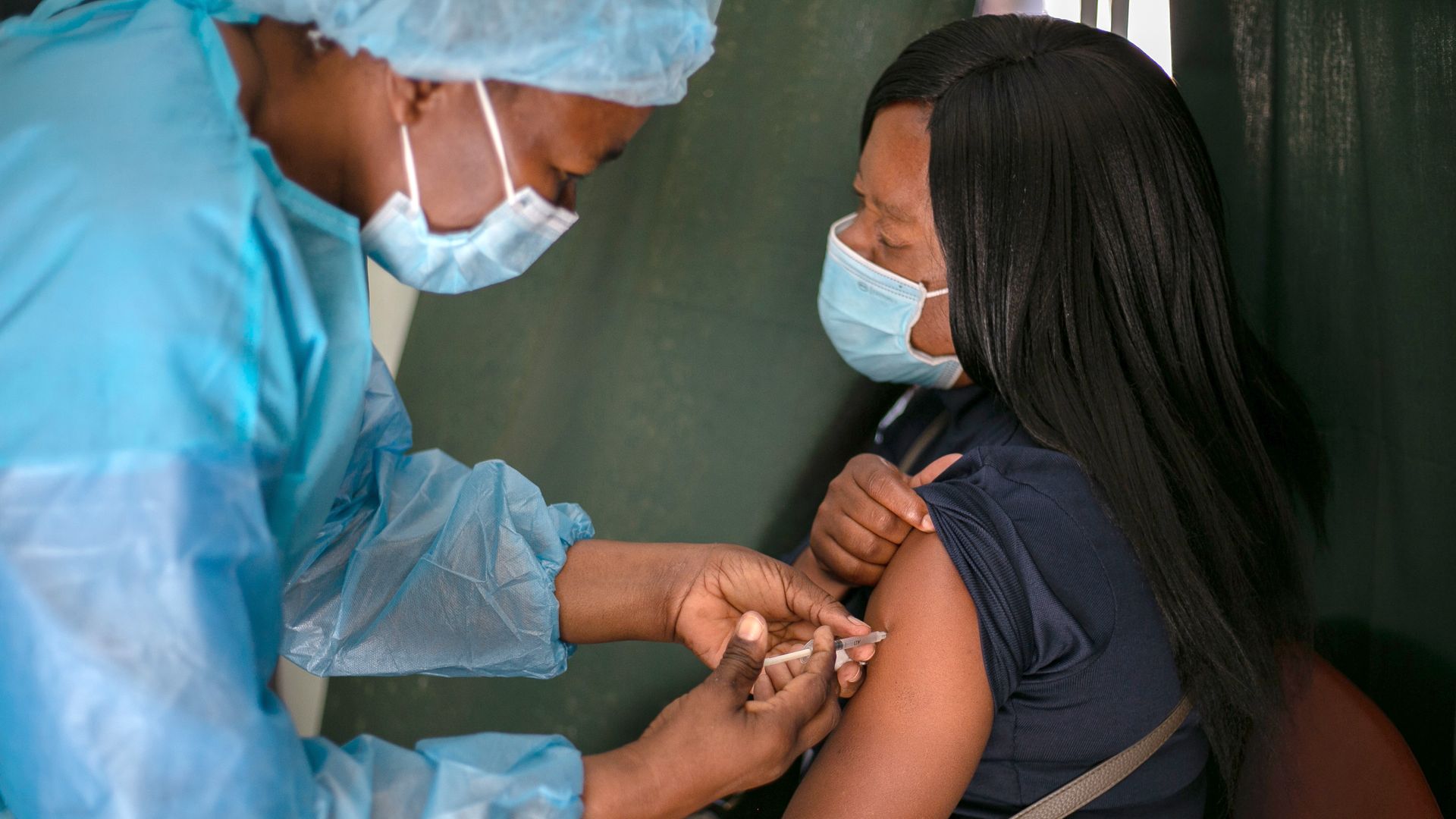 Picture of a woman in Zimbabwe receiving the vaccine
