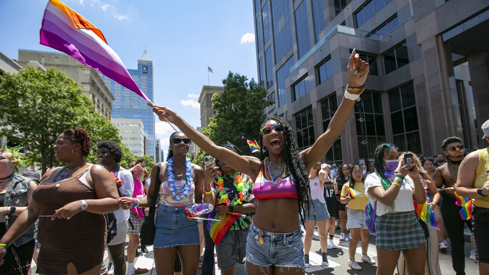 People wave rainbow flags during celebrations for Pride month on June 25, 2022, in Raleigh, North Carolina.