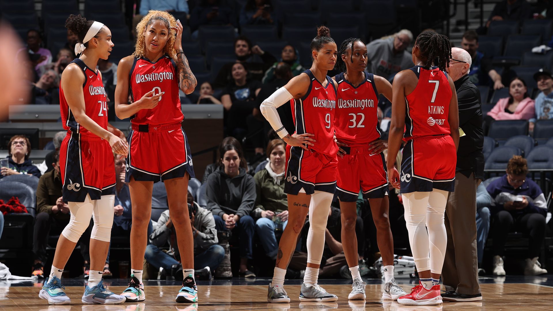 Mystics players huddle during a break.
