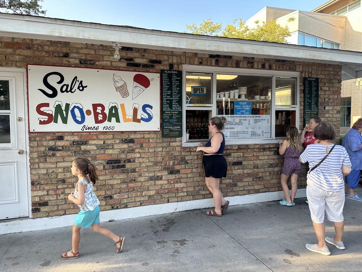 Photo shows people ordering at the window of Sal's Sno-balls in Old Metairie.