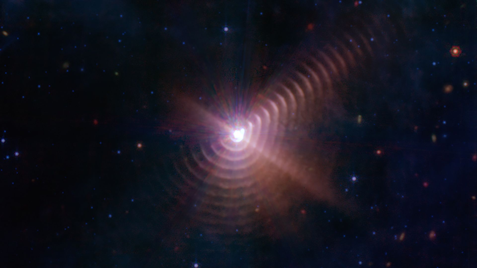 Rings of dust in purple radiating outward from stars.