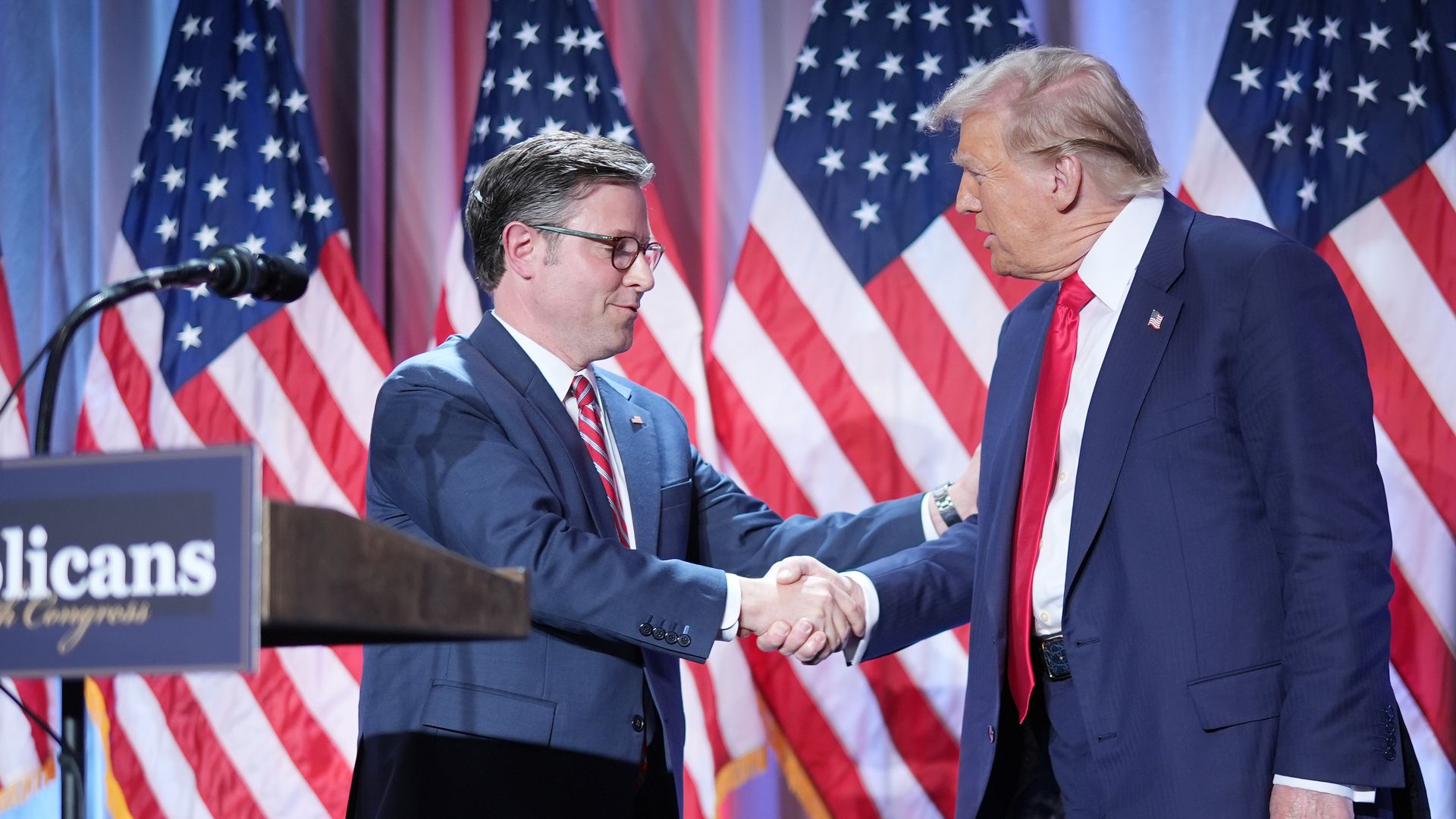 House Speaker Mike Johnson shakes hands with President-elect Trump.