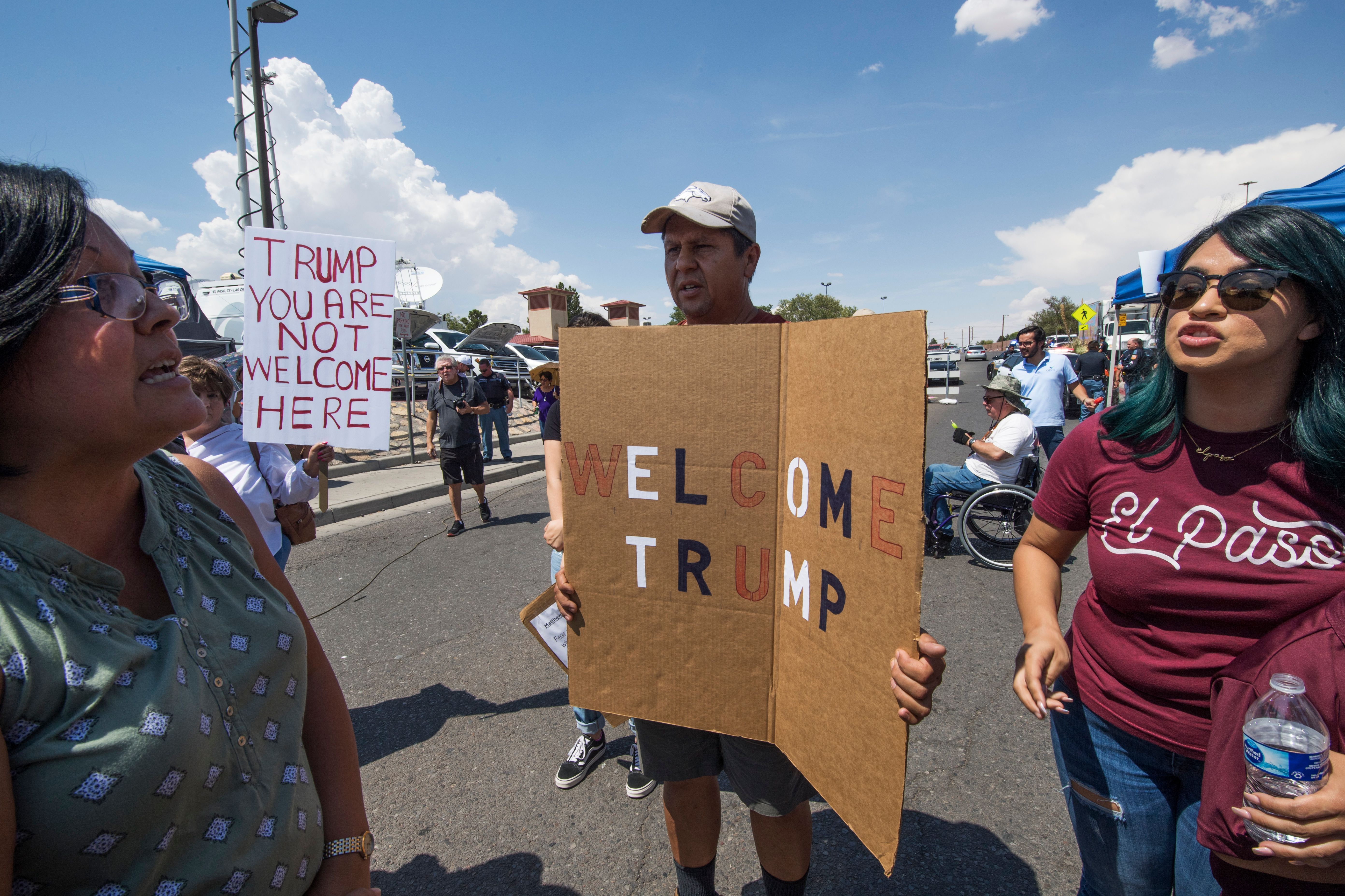 Anti-Trump protesters argue with Trump supporters outside the makeshift memorial to the victims of the WalMart shooting that left a total of 22 people dead, in El Paso, Texas, on August 7