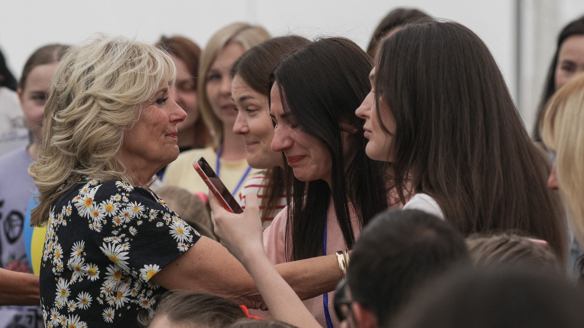 First Lady Jill Biden comforts a woman during a visit of the "Uruguay Gymnasium School" in Bucharest to meet Ukrainian refugee pupils and Ukrainian refugee teachers on May 7.