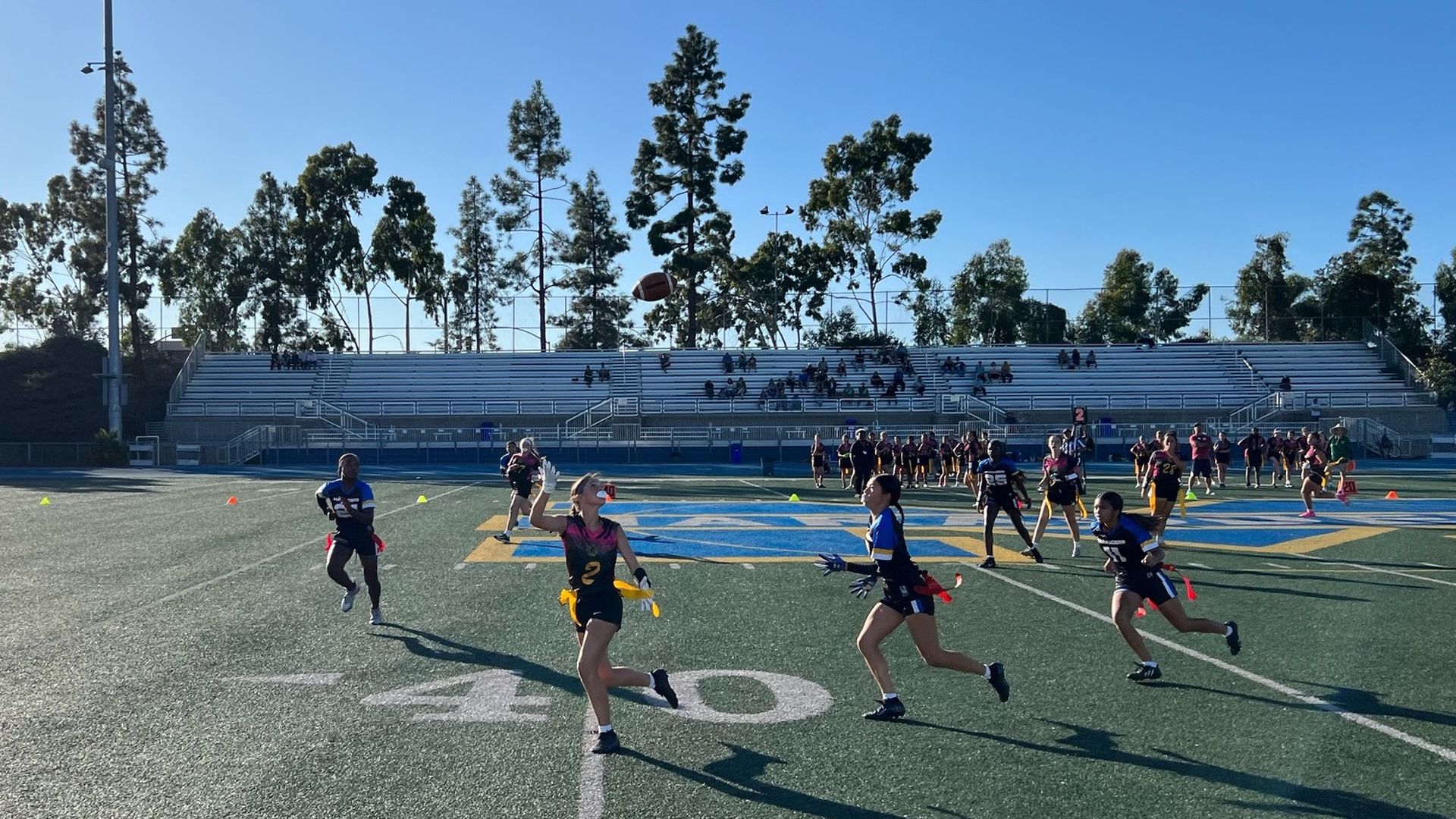 A girl tries to catch a pass during a flag football game.