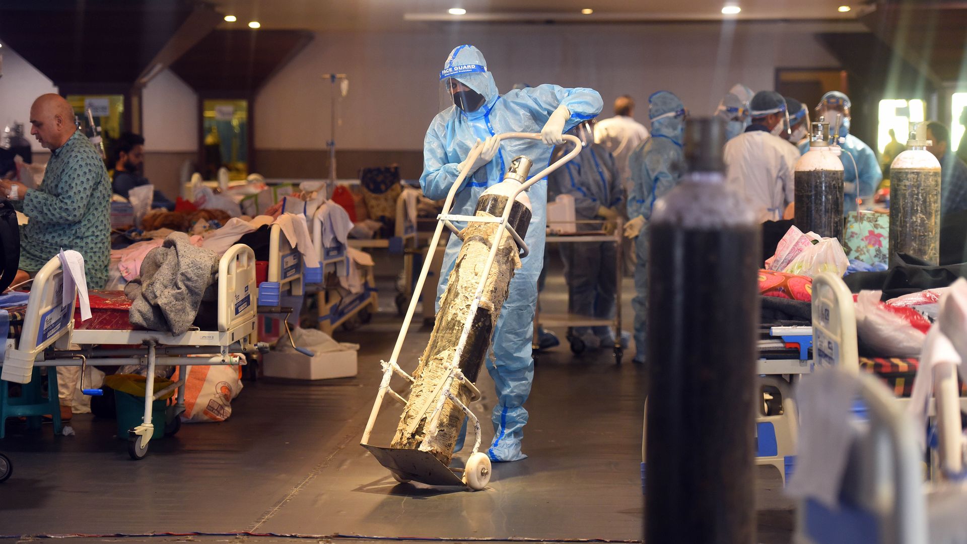 A health worker moving an oxygen cylinder in a coronavirus ward of a hospital in New Delhi.