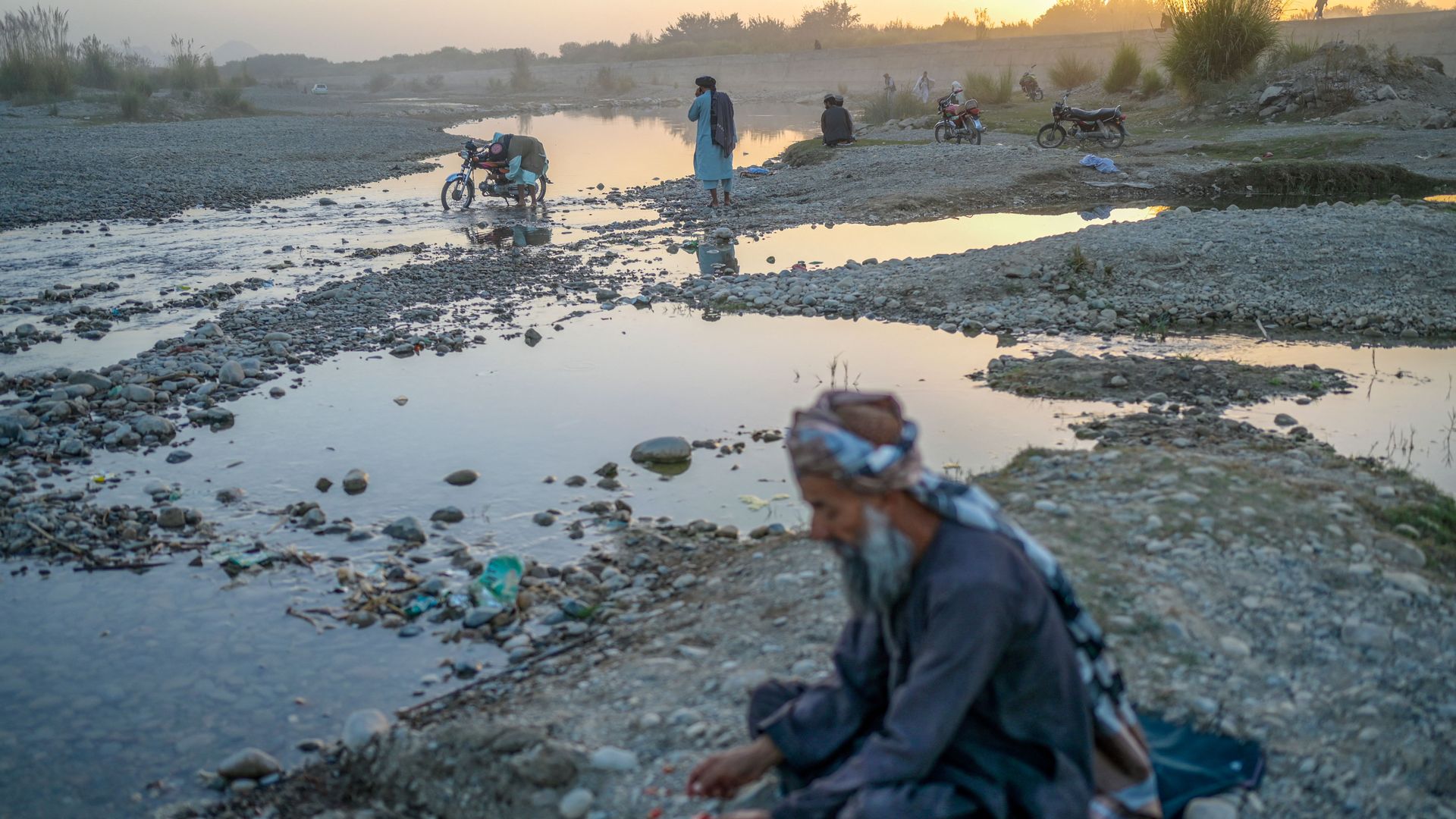 Photo of people in a riverbed