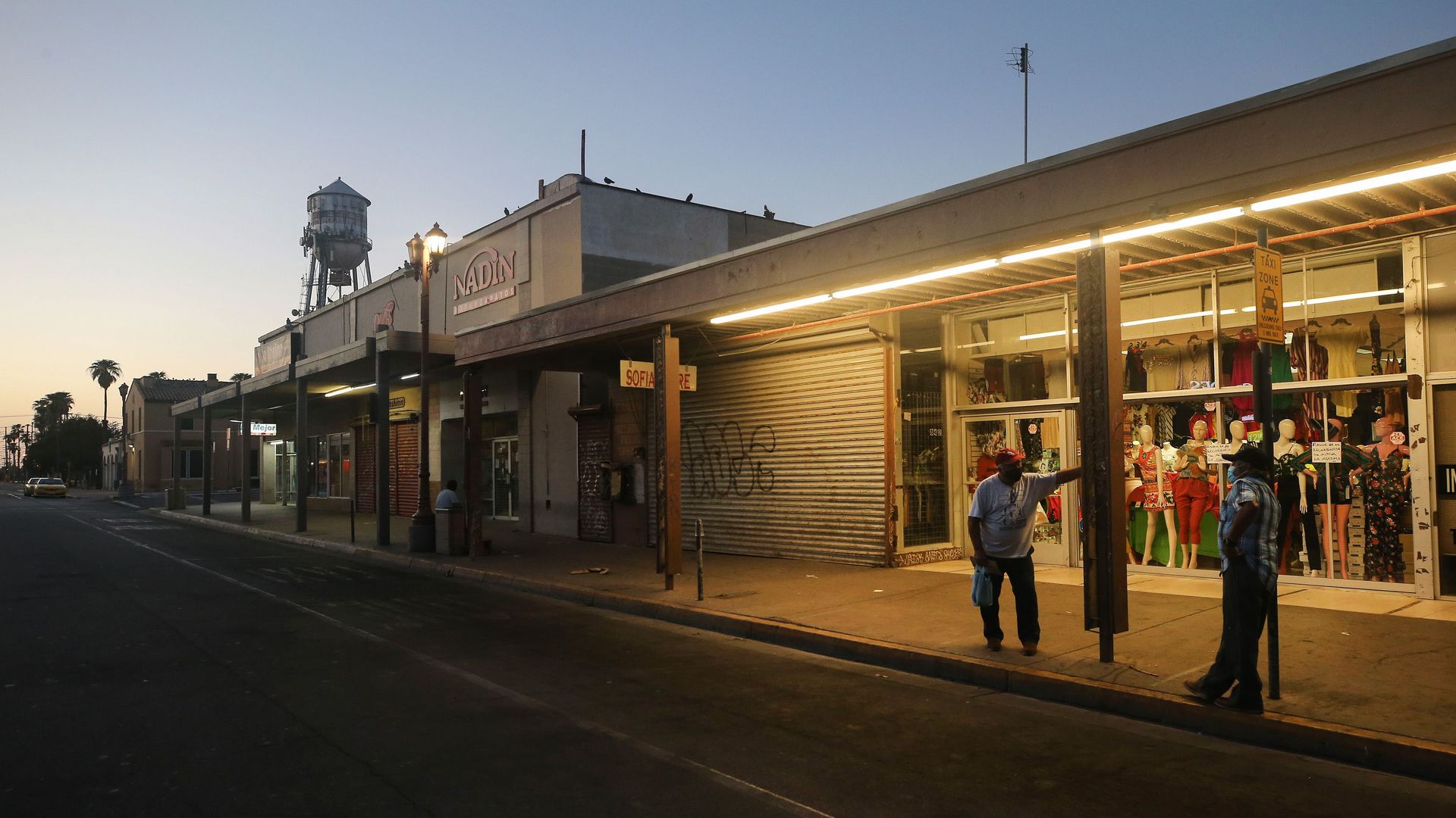 Men wait at dawn to be the first in line to fill out unemployment forms near the U.S.-Mexico border in Imperial County, which has been hard-hit by the COVID-19 pandemic.