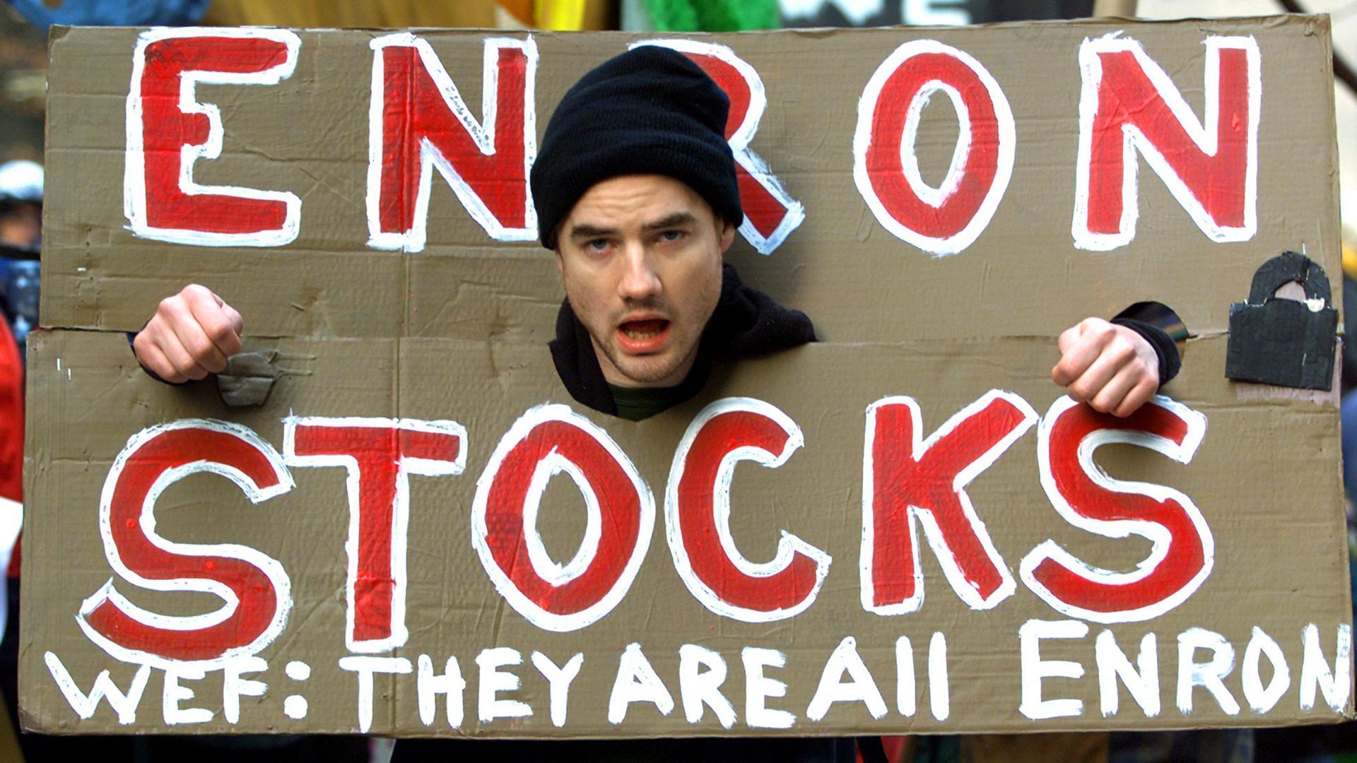 A demonstrator protests against the World Economic Forum and the Enron scandal in February 2002. The scandal stoked public outrage over the stock market. (PAUL J. RICHARDS/AFP via Getty Images)