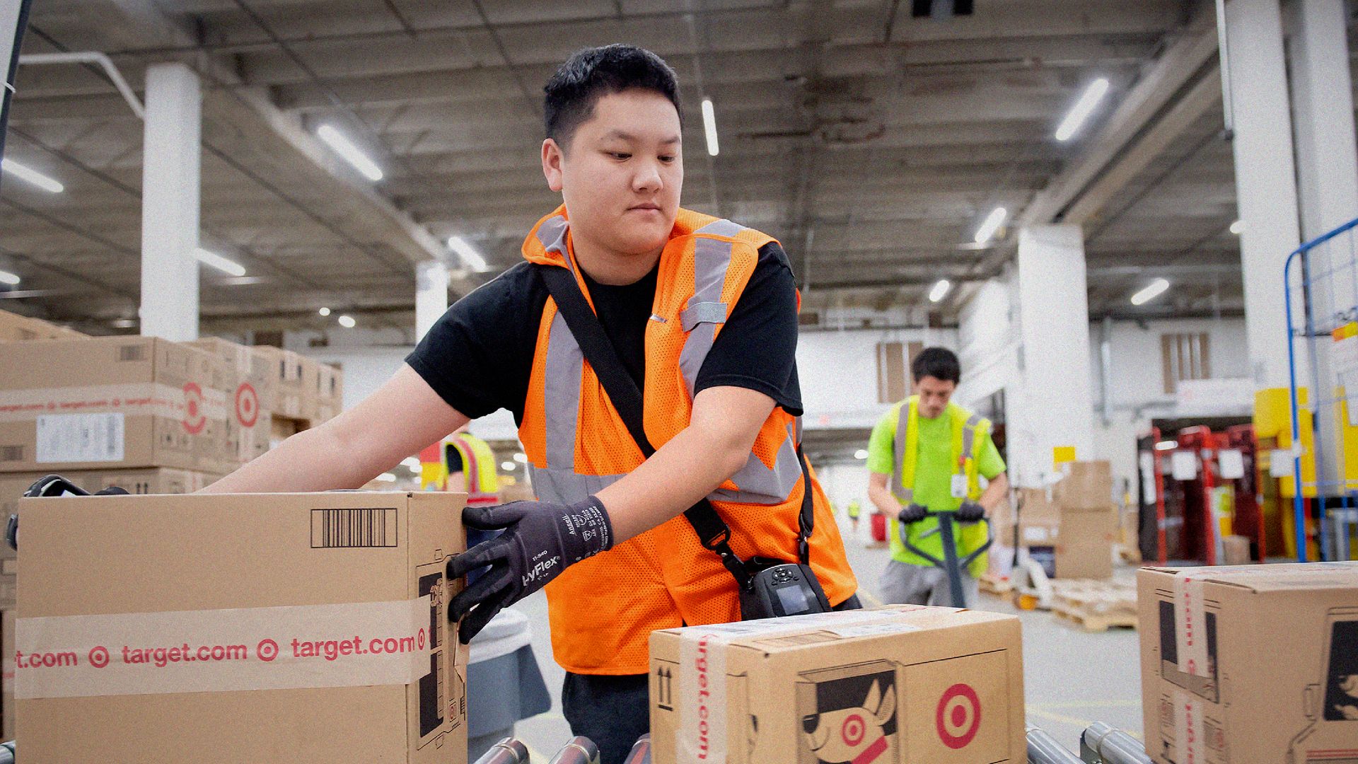 Target employee works in sortation facility moving boxes