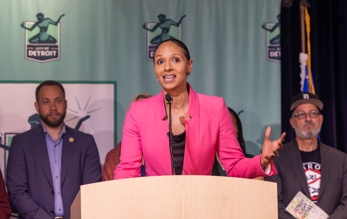 Sheffield speaks at a podium with the city of Detroit logo in the background