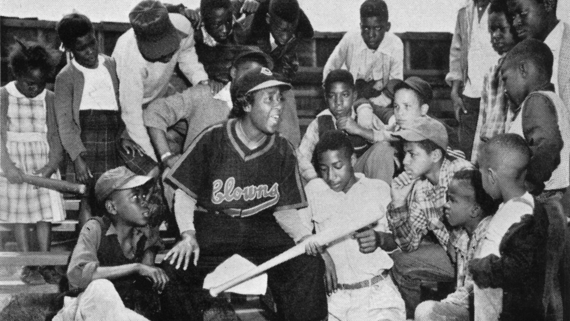 Toni Stone of the Indianapolis Clowns meets young baseball fans in 1953. Stone was the first woman to play professional baseball.