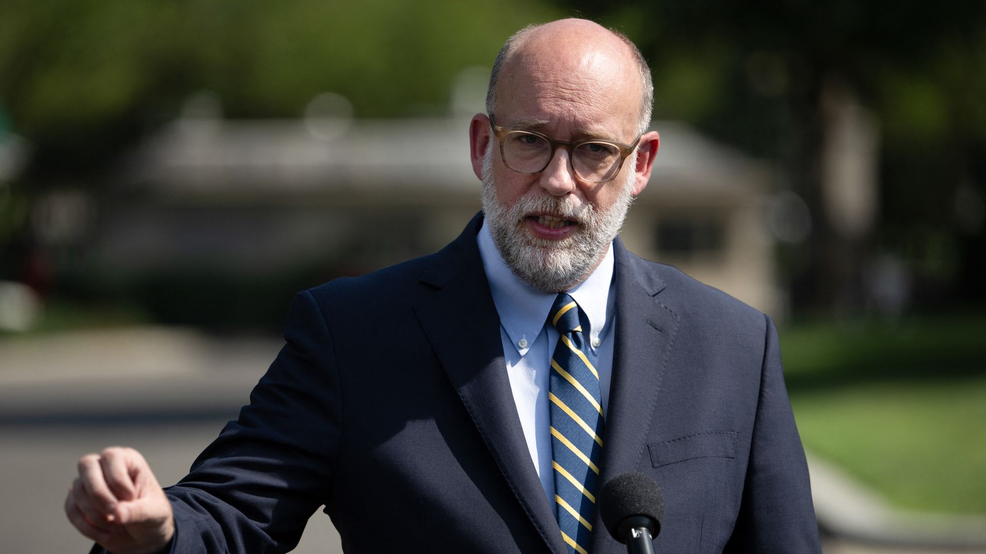 Russ Vought in a suit outside. 