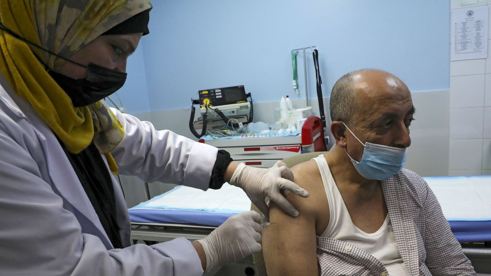 A nurse administers the COVID-19 vaccine to a Palestinian at the Al-Mezan Hospital in Hebron city, in the occupied West Bank