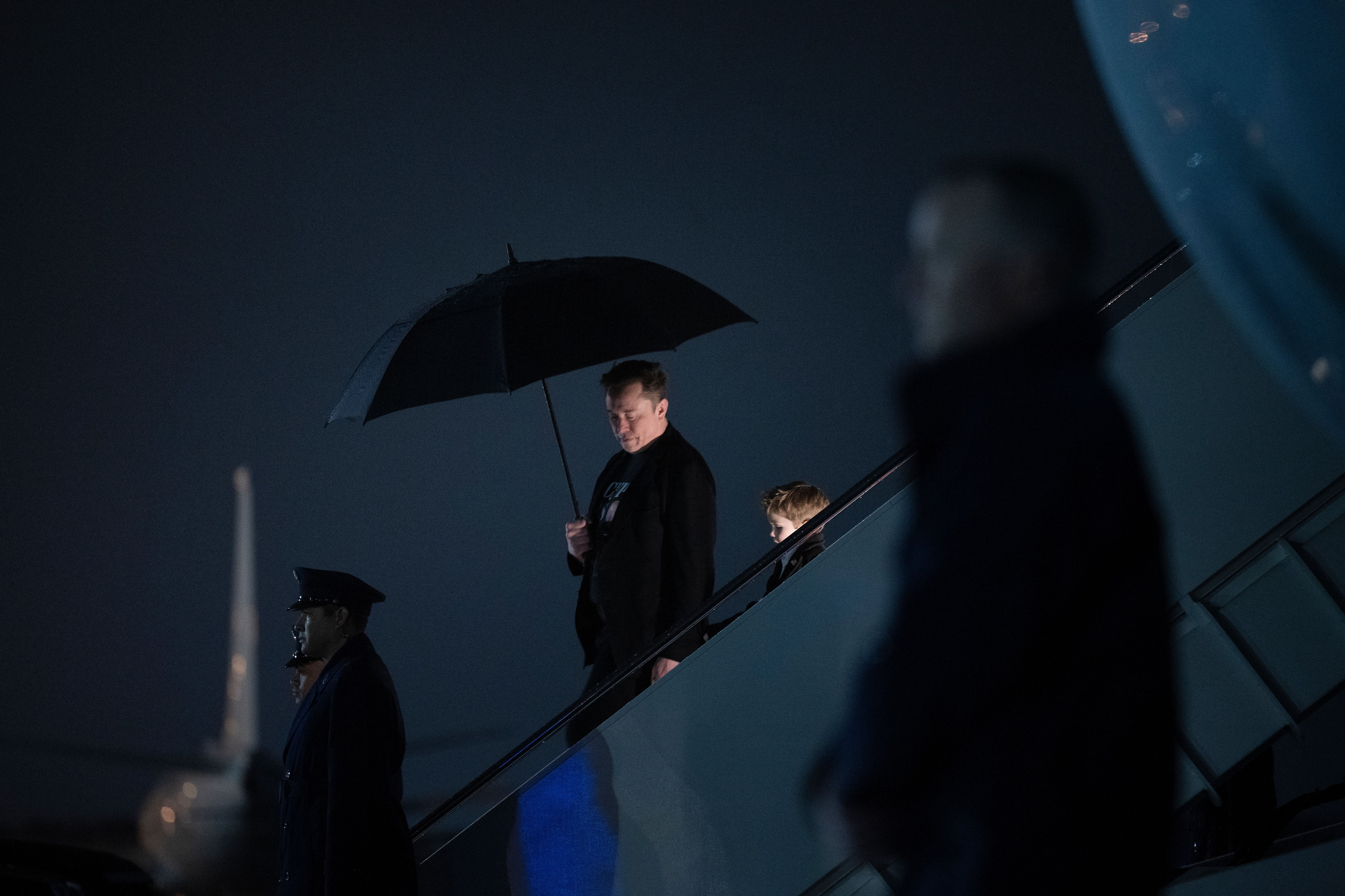 Elon Musk steps off Air Force One with his son after arriving at Joint Base Andrews on Monday.