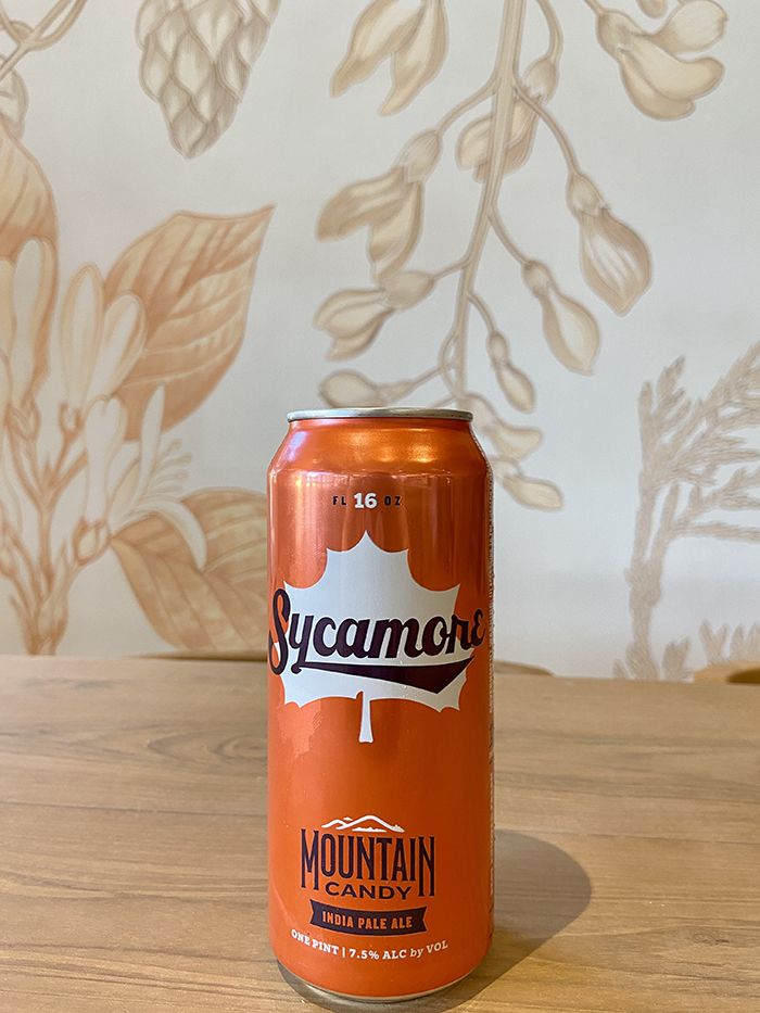 Sycamore's Mountain Candy beer in front of the new mural.