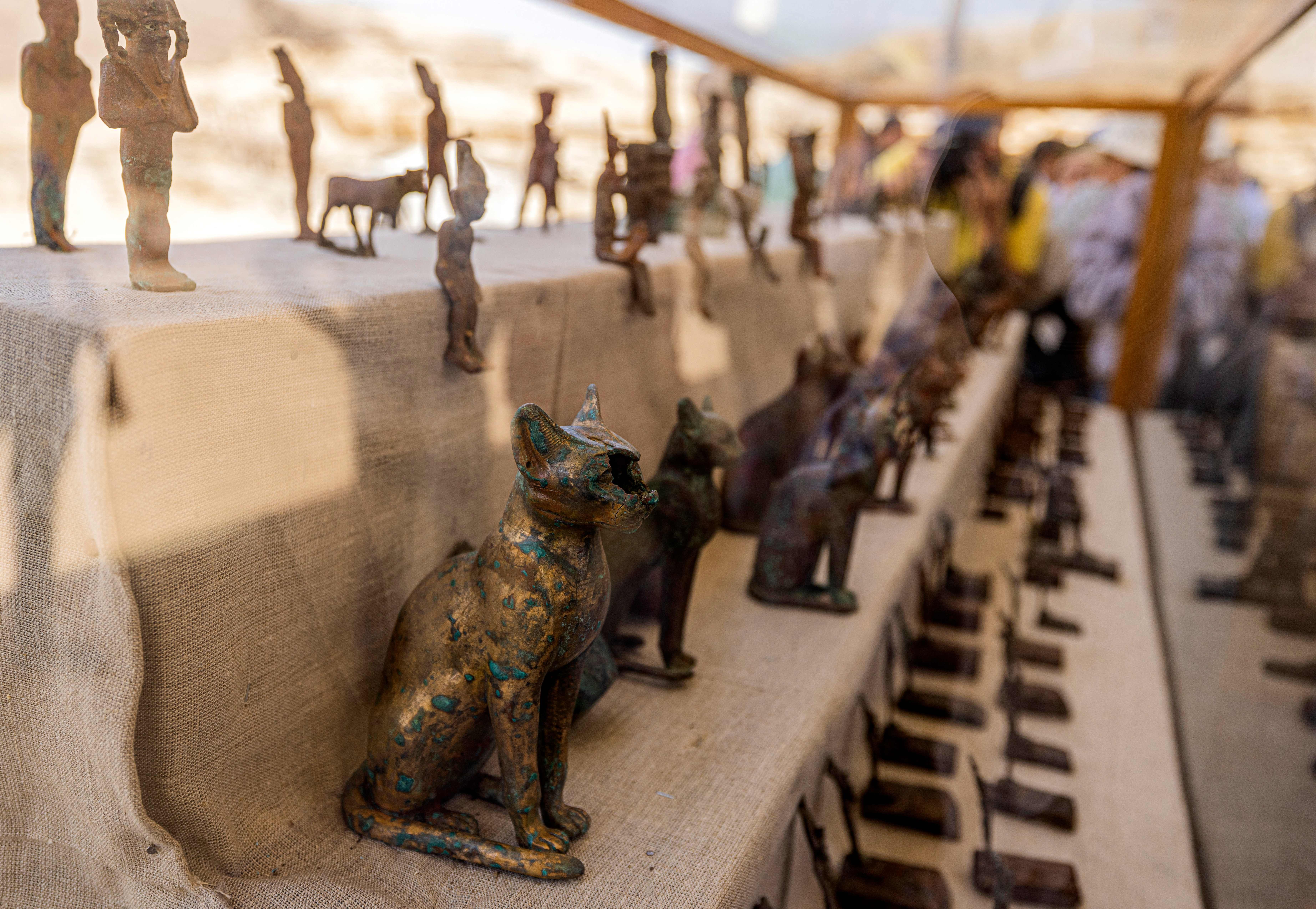 Statuettes and figurines depicting cats and Egyptian deities found in a cache dating to the Egyptian Late Period (around the fifth century BC).