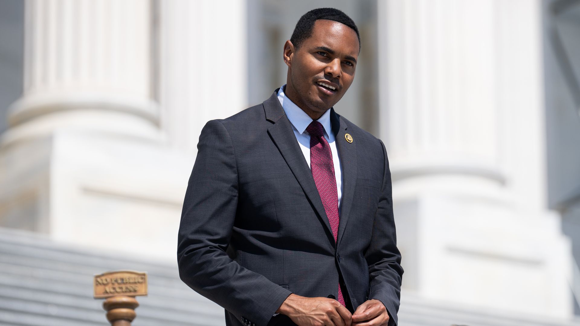 Rep. Ritchie Torres, wearing a gray suit and walking down the Capitol steps.