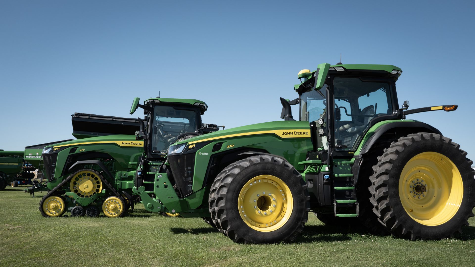 An image of John Deere tractors for sale at a dealership .