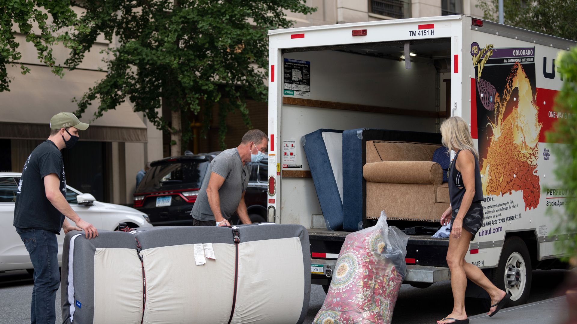 People loading furniture into a U-Haul.