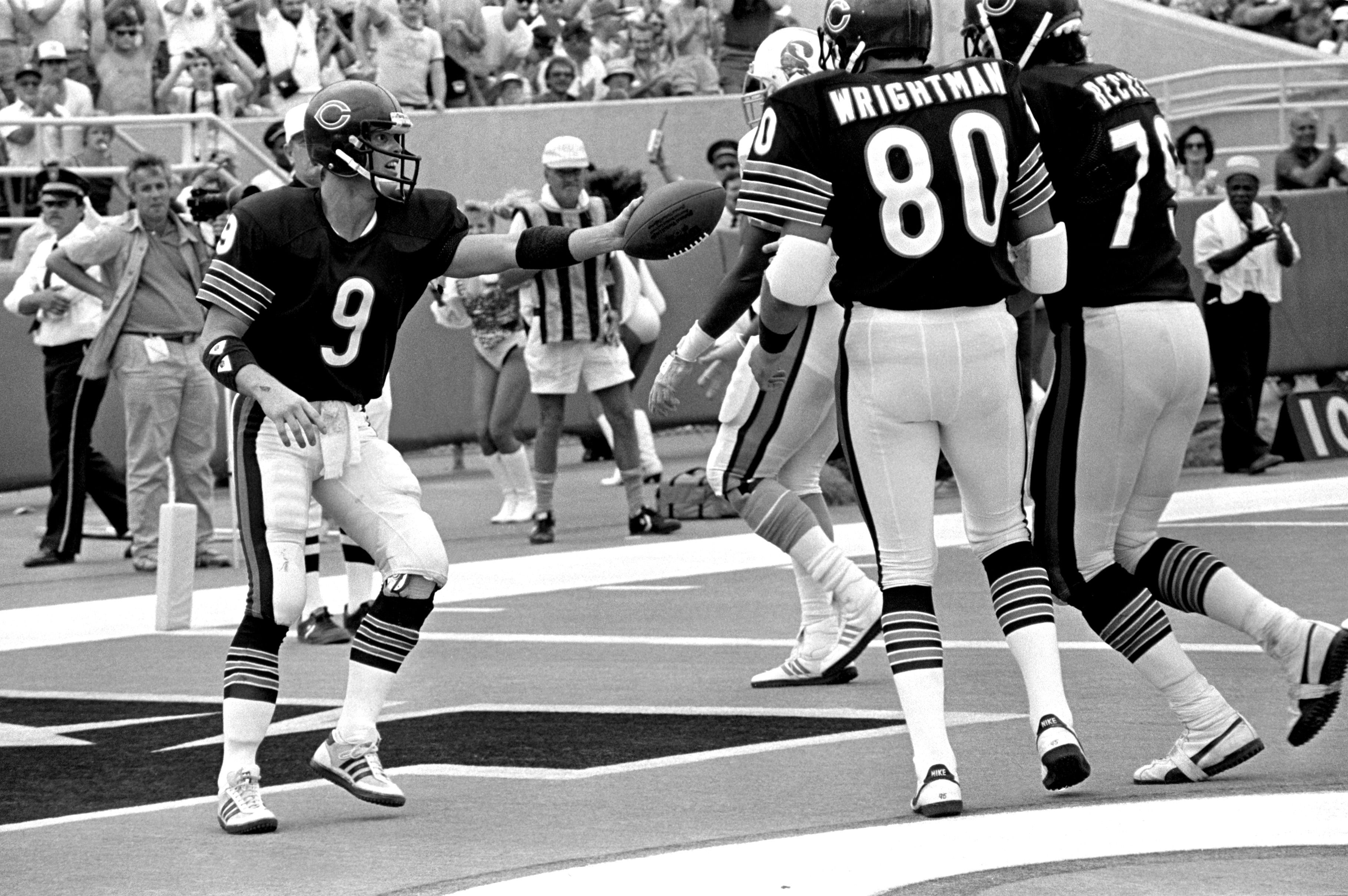Photo of football players in the endzone celebrating a touchdown. 